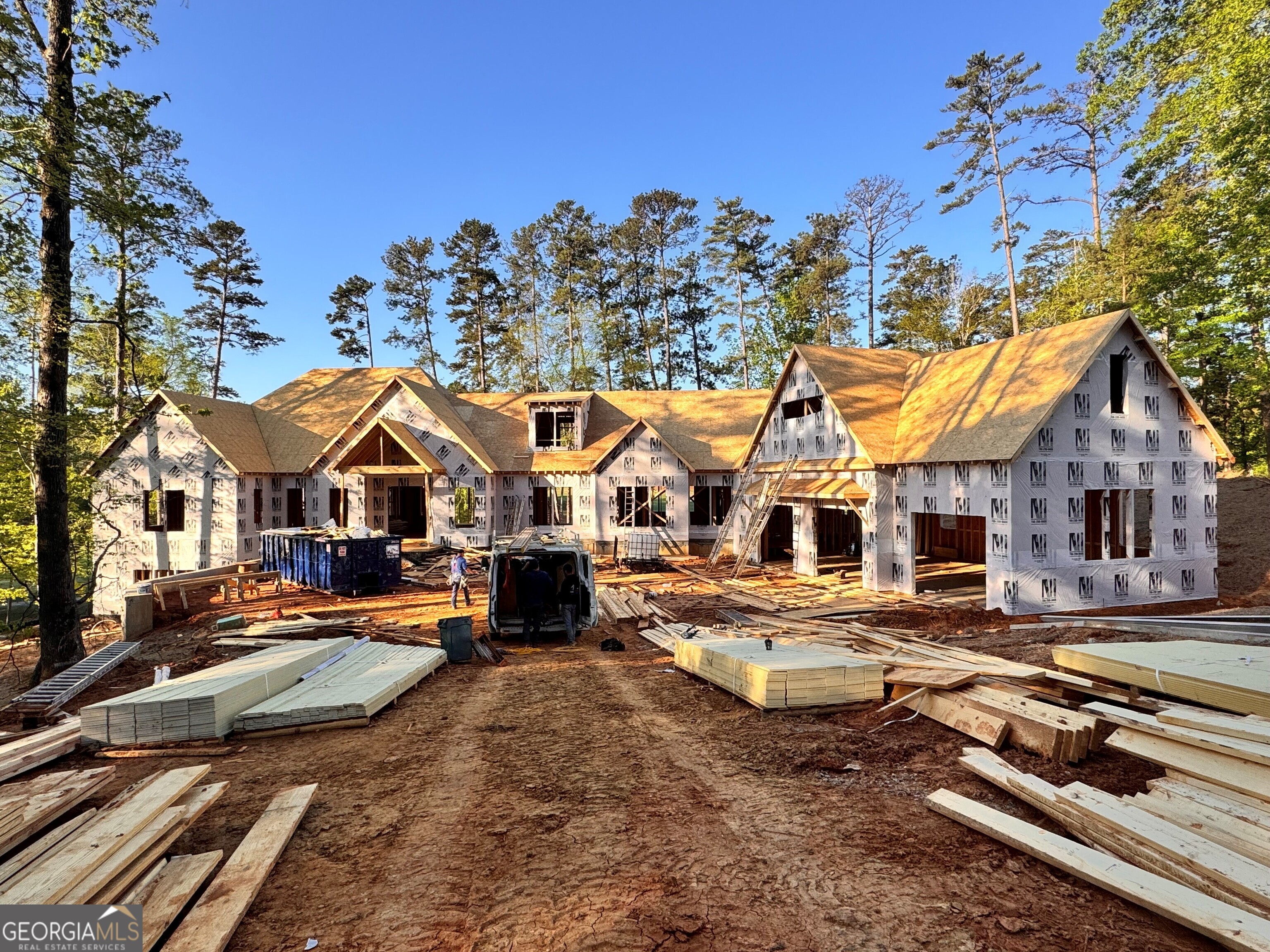 Experience elevated living in Reynolds Lake Oconee with this striking new-construction estate, perfectly positioned on over an acre overlooking the first fairway of The Cove at the National Golf Course. One of the largest lots available in the community, this custom-built home delivers a rare combination of space, privacy, and world-class golf views. Boasting over 7,000 square feet of heated living space, the residence offers a harmonious blend of modern elegance and timeless craftsmanship. The main level is designed for both everyday comfort and upscale entertaining, featuring expansive open-concept living areas, a luxurious primary suite, and a resort-style pool just steps away. The walk-out terrace level expands the home's versatility with additional bedrooms, a spacious recreation area, and direct outdoor access-perfect for hosting guests or enjoying quiet evenings under the stars. The state-of-the-art chef's kitchen is equipped with premium Viking appliances, custom cabinetry, and an oversized island ideal for gathering. Above the three-car garage, a finished bonus space offers flexibility for a media room, home office, or private guest suite. Located within walking distance of the National Tavern and driving range, this home offers unmatched access to the best of Reynolds. Tucked at the end of a private cul-de-sac, it provides a peaceful retreat without sacrificing convenience. Still under construction, the home presents a unique opportunity for buyers to select final finishes and personalize it to their taste. Club membership is available.