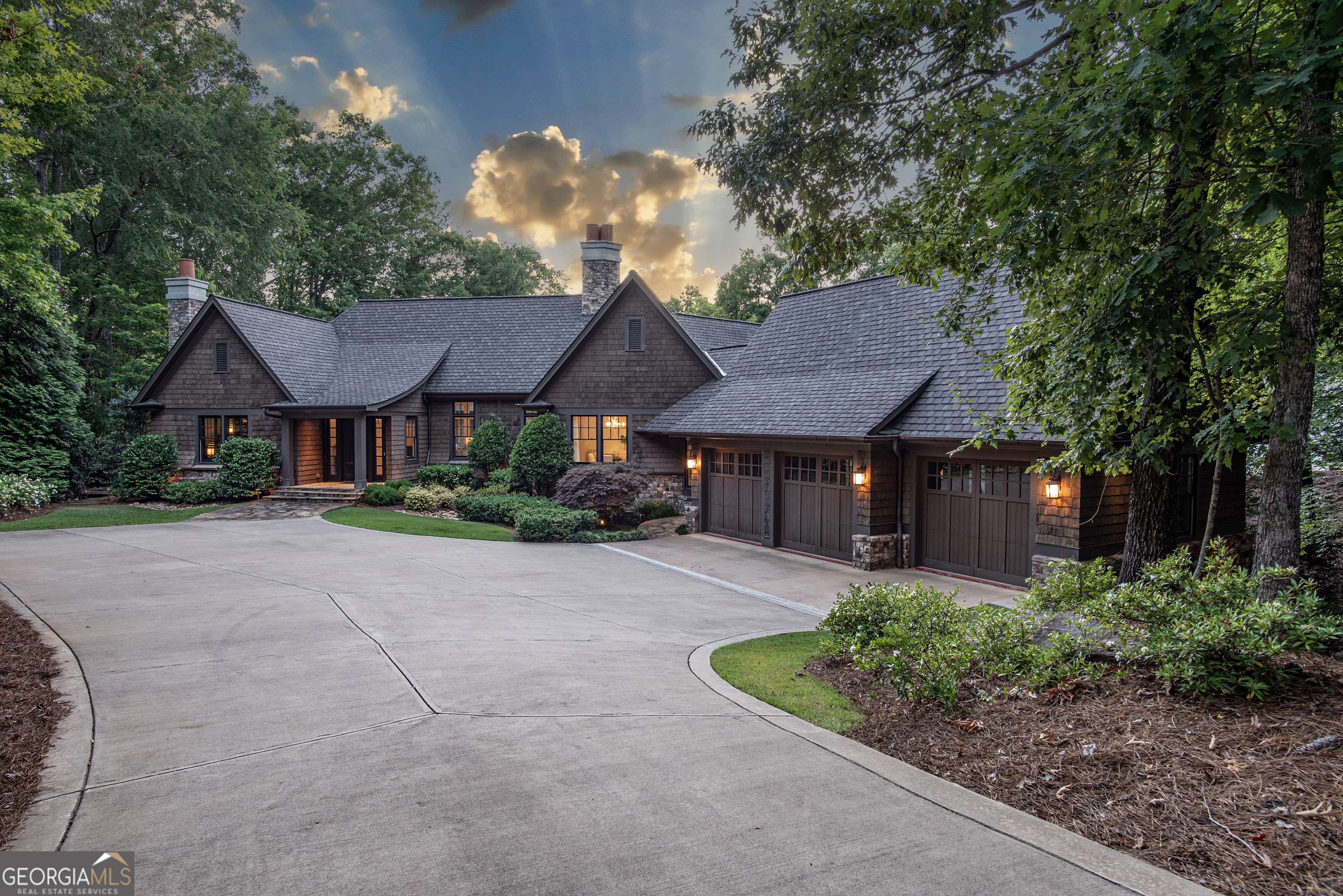 Stunning Lakefront Home Designed by Architect Don Beck in the sought-after Falling Creek Neighborhood of Reynolds Lake Oconee. Welcome to your dream lake house! Nestled in the neighborhood of Falling Creek, this timeless and elegant home offers breathtaking big water and sunset views. Enjoy ultimate privacy with almost an acre of prime lake property and exclusive access to the Jack Nicklaus golf course by boat, as well as close proximity to Richland Point, the new National golf course, and the Reynolds walking trail. Set on a gorgeous lakefront property with big water near Horseshoe Bend and across from Great Waters, this superbly crafted home boasts 5 bedrooms, 5 full baths, and 3 half baths. Designed by a renowned interior designer, the residence combines elegance and comfort in every detail. The main level features a spacious great room and dining area, a sleek and modern kitchen with high-end appliances, butlers pantry, a bar and a large lake-view breakfast area that opens onto a generous screened porch with a cozy fireplace. Additionally, the main level includes a custom office and a luxurious primary suite with a spa-like bath. Descending to the lower level, you'll find a welcoming family room with a stone fireplace, a full bar, a wine room, and four sizable guest suites, each with its own private bath. The beautifully landscaped backyard is perfect for lounging by the lake and enjoying spectacular sunsets from your private boat dock or watching the spectacular fireworks from your yard. Located just minutes by boat from the Great Waters golf course, The Overlook restaurant and the Ritz Carlton, the location of this home is unparalleled. Don't miss the opportunity to make this stunning lakefront residence your own this summer! Membership to the club is available.