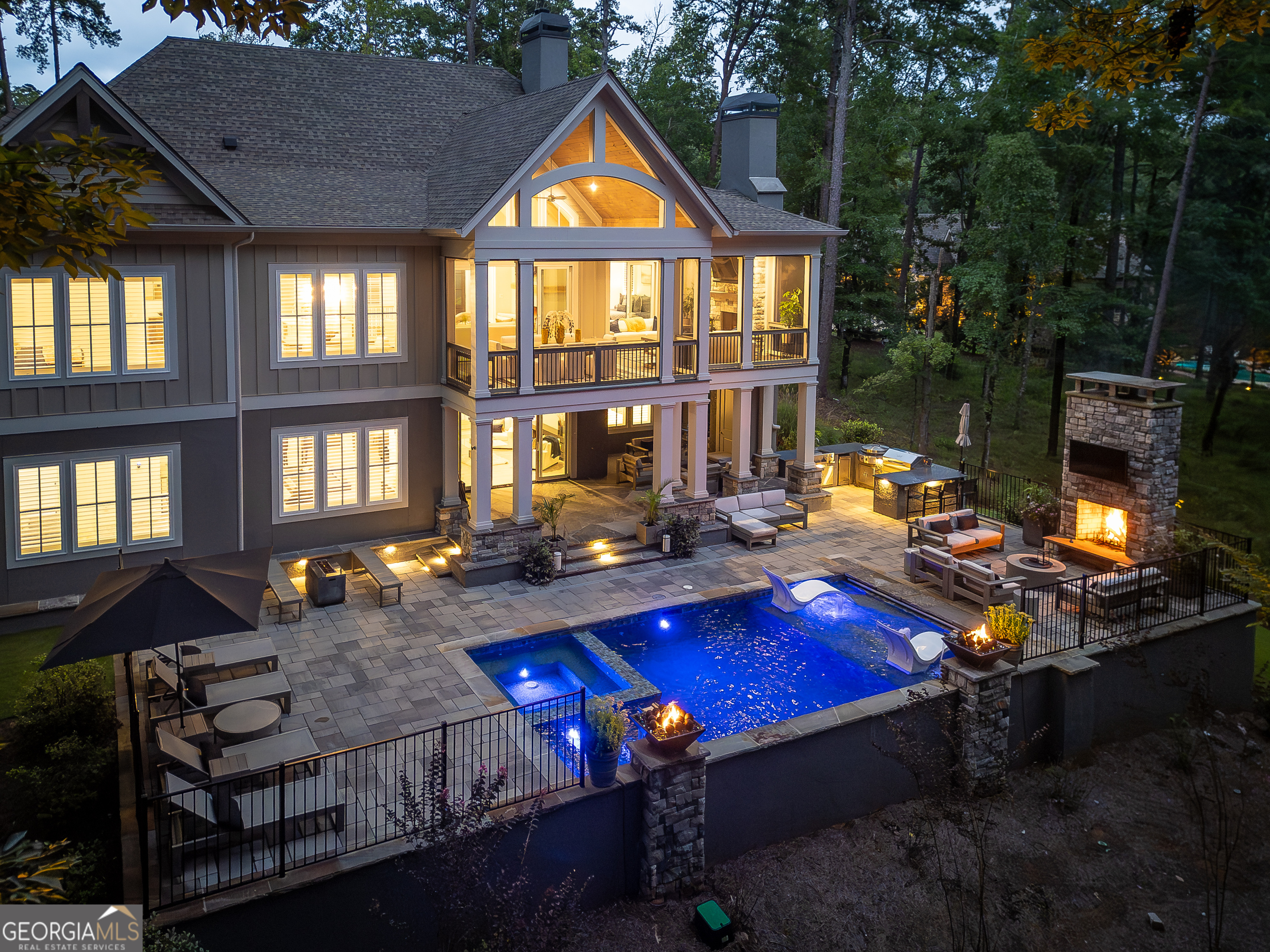 Elegant custom-built home in Reynolds Lake Oconee - located at the end of a quiet cul-de-sac in one of the community's most sought-after areas. Welcome to this exquisite 5-bedroom, 5 full and 2 half-bath home, built in 2021 and thoughtfully designed with luxury in mind. This like-new residence features three fireplaces, plantation shutters, and a Sonos surround sound system throughout. Soaring cathedral ceilings and gleaming hardwood floors set the tone the moment you step inside. The gourmet kitchen is a chef's dream, complete with top-of-the-line stainless steel appliances, a gas range, double ovens, Cambria quartz countertops, and a spacious island-perfect for entertaining family and friends. Seamless indoor-outdoor living awaits with a screened-in porch featuring Trex decking, a gas-assisted wood-burning fireplace, and an outdoor dining area ideal for al fresco meals. The terrace level features two additional bedrooms, a full bar, and a spacious recreation room-ideal for entertaining guests or hosting family fun. Outside, enjoy your private oasis with a heated pool, spa, outdoor fireplace, and summer kitchen, all overlooking tranquil views of Lake Oconee. Owners have been approved to create a private pathway from their backyard to the gazebo and dock for easy lake access. Bordered by 18.77 acres of protected Reynolds conservation land that will never be developed, this property offers unmatched privacy and serenity while being in the heart of one of Georgia's premier lake communities. With a golf membership available, you have access to seven Championship courses, dining and outdoor recreation opportunities.