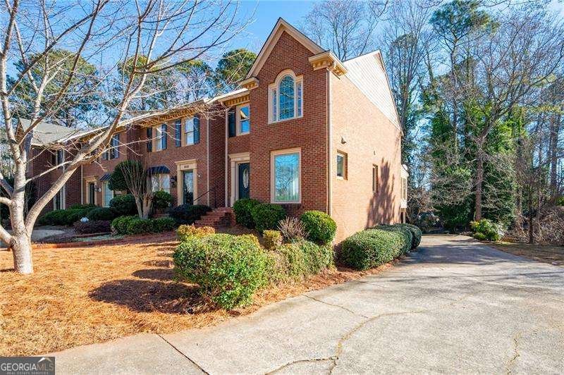 Seller is offering a $5,000 buyer credit for closing costs or rate buydown! Fabulous three story townhome in the heart of Marietta with no HOA! Beautiful light-filled brick end unit with a landscaped front yard and a brick paver walkway. Updated kitchen featuring dark granite counters, stainless steel appliances, new fixtures, and freshly painted cabinetry. Separate dining room with a new chandelier, crown molding, and room for a crowd. Spacious living room with a brick gas fireplace. Charming corner sunroom perfect for a home office or library. New LVP flooring throughout foyer, kitchen, and dining room. New double pane vinyl windows including four picture windows allowing for ample natural light. Upstairs features a large primary bedroom with duel closets, a remodeled bathroom, and an antique vanity. Upstairs secondary bedroom with its own remodeled ensuite. Spacious finished basement with plenty of storage closets and room for a home theatre. Located 1 mile from Kennesaw Mountain National Battlefield Park and only 2 miles to the Historic Marietta Square. This one truly will not last.