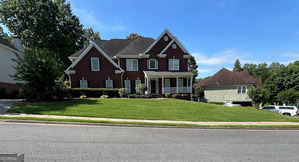 Beautifully maintained 5BR/3.5BA home in sought-after Hamilton Mill! Features include a gourmet kitchen with granite, stone backsplash, SS appliances, butler's pantry, and double pantry. Two-story family room with grand wall of windows and hardwood floors throughout main. Luxurious master suite with sitting area, frameless shower, jacuzzi tub, and marble floors. Finished basement with full kitchen, bar, game room, bedroom, bath, and storage-perfect for in-laws or guests. Enjoy a private, level backyard with oversized deck, covered porch, and professional landscaping. Side-entry garage, new siding, fresh paint, and spacious laundry room. Move-in ready! Professional photos to be added 6/27.