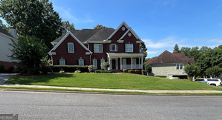 Beautifully maintained 5BR/3.5BA home in sought-after Hamilton Mill! Features include a gourmet kitchen with granite, stone backsplash, SS appliances, butler's pantry, and double pantry. Two-story family room with grand wall of windows and hardwood floors throughout main. Luxurious master suite with sitting area, frameless shower, jacuzzi tub, and marble floors. Finished basement with full kitchen, bar, game room, bedroom, bath, and storage-perfect for in-laws or guests. Enjoy a private, level backyard with oversized deck, covered porch, and professional landscaping. Side-entry garage, new siding, fresh paint, and spacious laundry room. Move-in ready! Professional photos to be added 6/27.