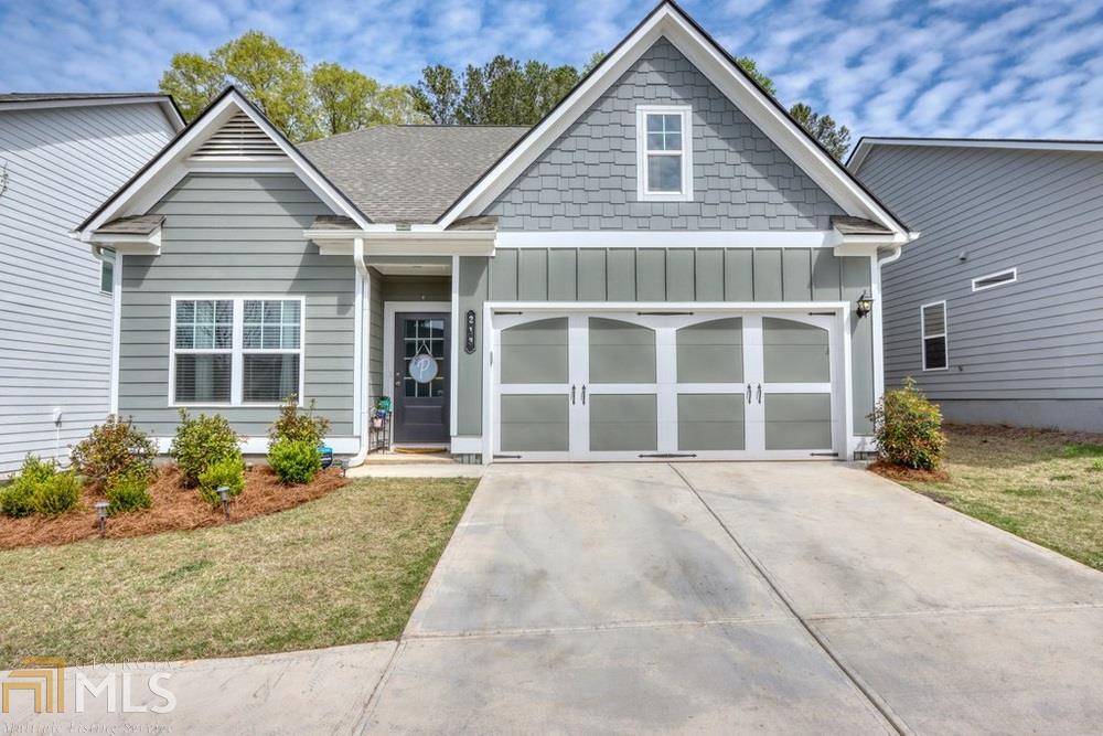 Better than new, adorable master on main home in Ball Ground! This great home is bright and has a great layout with the spacious master on the main and two secondary bedrooms upstairs. The kitchen has gorgeous white cabinets and overlooks the family room. Your family will love the covered rear porch and backyard oasis.