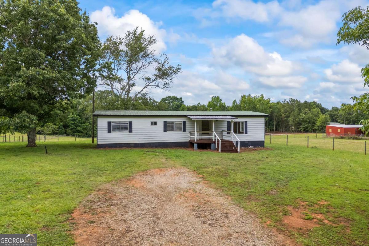 If you've been looking for quiet living on a little land, this might be the one. This 3 bed, 2 bath mobile home sits on 2 acres with a metal roof, an updated kitchen, and a front porch that's just right for slow mornings. There's some fencing in place, space to stretch out, and a feeling of privacy that's hard to come by. The title is retired and if you want peaceful county living, this home is for you.