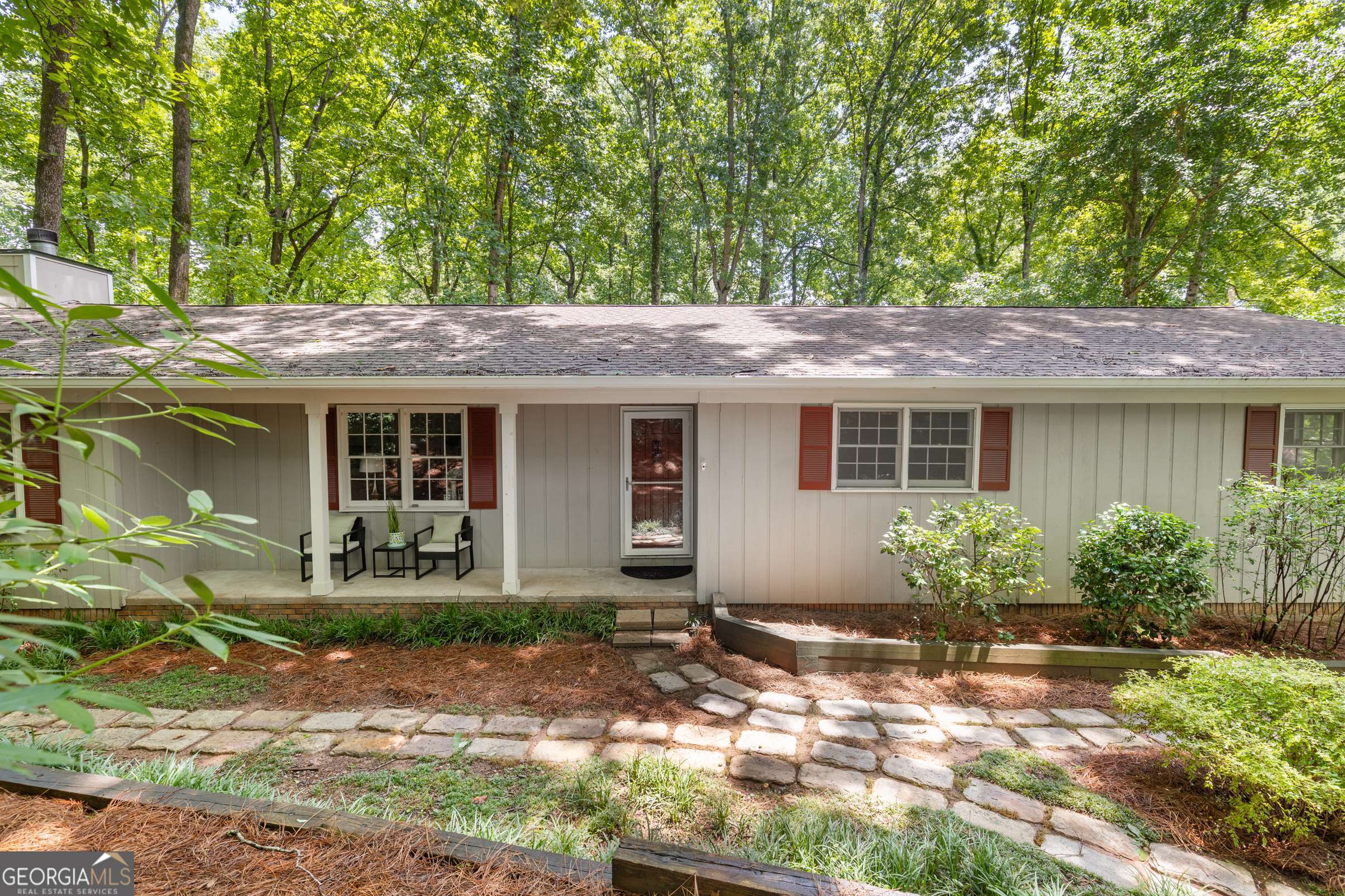 Tucked away on a quiet cul-de-sac in East Cobb, this beautifully updated ranch sits on a private, 3/4-acre lot that offers a rare combination of lush natural surroundings & open, usable space. From the moment you arrive, you'll notice how the mature front landscaping creates a natural buffer from the street, offering a sense of calm and privacy. Step into the massive, level backyard-a grassy, park-like setting surrounded by woods on all sides. It's the kind of outdoor space that feels like your own secluded retreat, perfect for relaxing, entertaining, or letting kids and pets roam freely. Inside, you'll find newly refinished REAL hardwood floors throughout the entire home and a spacious layout perfect for both daily living and hosting guests. The welcoming foyer opens to a private library or den, ideal for a home office or cozy reading space. The vaulted great room is truly impressive-huge and filled with natural light, it features a fireplace and French doors that open to the expansive back deck. The great room flows seamlessly into the updated kitchen, which boasts a massive island perfect for gathering, abundant cabinetry and counter space, newer stainless appliances, and even a wine fridge. A wall of built-in cabinets offers extra storage or a serving area. The home offers three bedrooms on the main level, including a spacious primary suite with two closets. Step outside to a large deck that overlooks the private backyard oasis-where it's so peaceful, you'd never know you had neighbors. A full unfinished basement provides tons of storage or potential for future living space. Located in a top-rated school district and just minutes from I-75, this home delivers the best of both worlds: convenience and total privacy.