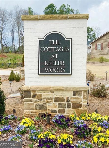 Fantastic opportunity to purchase a beautiful lot and build a custom home in the exquisite neighborhood of The Cottages at Keeler Woods - located close to the Historic Marietta Square, Kennesaw Mountain and in West Side Elementary district. Lot can be purchased with adjoining lot 21 if a double lot is desired. Custom home must be designed by Caldwell Cline and built by Elliott Custom Homes. Lot sits across from the neighborhood green space where you can enjoy use of the community pergola and fire pit. Several pre-designed house plans by Caldwell-Cline are also available to use. The Neighborhood is gated and in a great location close to area shopping, restaurants, and schools!