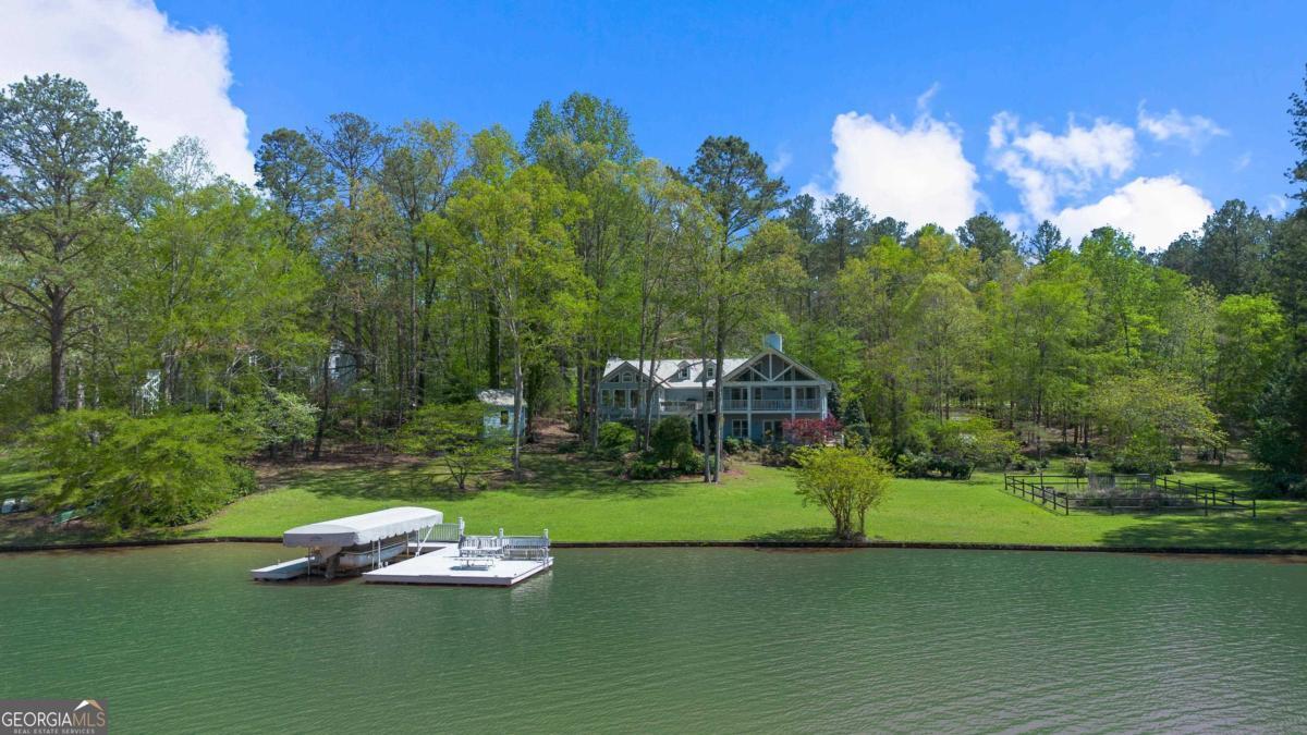 unusual opportunity on richland creek side of lake oconee - a highly coveted area featuring reynolds' crown jewel community, the homesteads, across the cove & the lake area's newest, private equity membership golf course, the hideaway, 1 lot away! comprised of two lots combined to equal a generous 1.82 acres & over 290 feet of water frontage, greene co. says it can be subdivided back into two lots. one max dock currently. home is being sold as-is - a project with tons of upside considering the exquisite, thoughtful development occurring. privately situated back off the road & wooded in the front, there are expansive views on a level lot. great room with a fireplace, open kitchen, primary suite on the main with second cozy fireplace, elevator access to the garage beneath. second ensuite bedroom on main level, & an office. finished & conditioned space upstairs could be third bedroom.