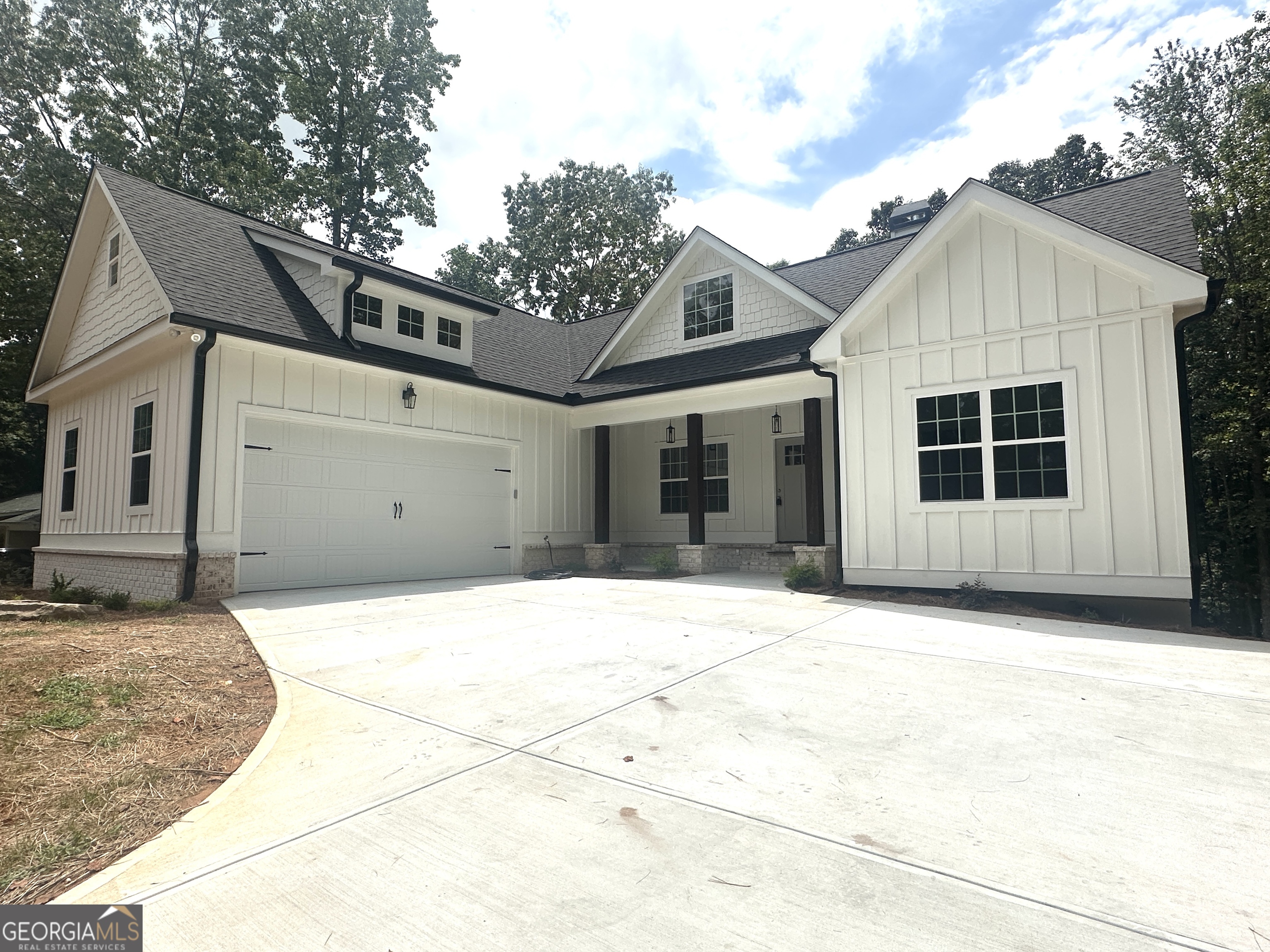 Stunning, bright open concept Craftsman Style Ranch with finished basement, located just minutes from Lake Lanier! Enjoy nearby LAKE AMENITIES WITHOUT LAKE PRICES! This new 4-bedroom, 3 bath home is conveniently located near Robinson Park. NO HOA! The Rocking Chair Front Porch invites you inside to spacious soaring 16' ceilings in the massive great room area featuring a wood burning fireplace, and opening to a covered back porch overlooking a large backyard.The kitchen has tons of natural light with stainless steel appliances, and granite counter tops. Master suite on the main level has an abundance of closet space, and a gorgeous master bath. On the main level are two additional bedrooms and 1 bath. Enjoy a finished daylight basement, with a bedroom and bath, as well as flex space, and lots of storage. Separate Trane HVAC systems for main level and basement. Oversized side entry garage for your vehicles. You will want to make this home your own!!!