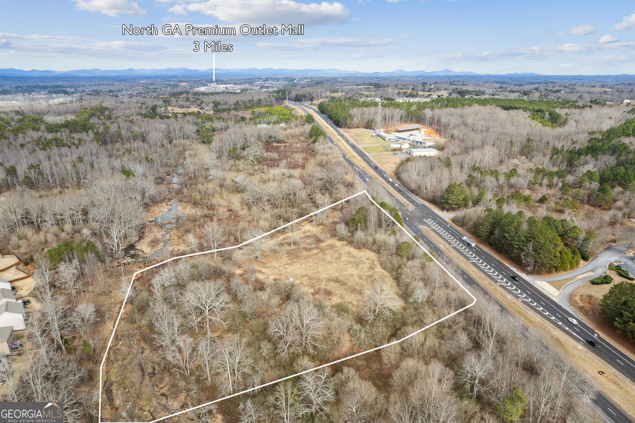 Excellent Commercial Industrial zoned (M1) property in Forsyth County. Highway GA 400 site SW of Jotem Down Road with approximately 870' of road frontage. Just North of the Don Jackson Jeep Dealership and Caterpillar Dealership. The site has access to both North bound and South bound lanes of GA 400 with a deceleration lane and median cut on the East side of GA 400.