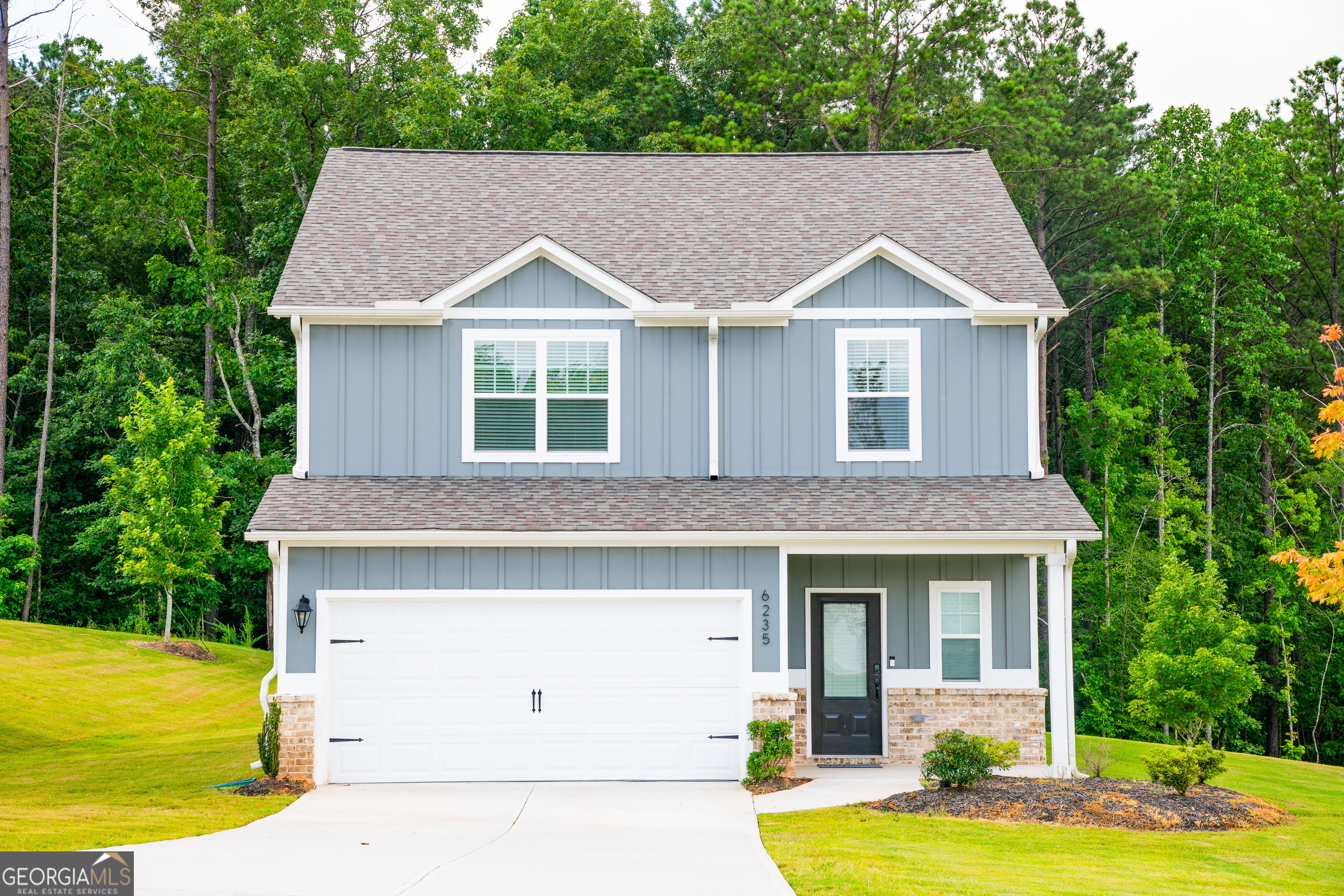 Welcome to 6235 Nathaniel Lane, a beautifully maintained 4-bedroom, 2.5-bath home nestled on a rare and spacious 1.09-acre leveled lot in the highly sought-after Chestnut Ridge community of Fairburn, GA. This modern two-story home offers an open-concept floor plan with luxury vinyl plank flooring, a bright living room, and a stylish kitchen featuring granite countertops, stainless steel appliances, and white shaker cabinets. The oversized primary suite boasts a walk-in closet, dual vanities, and a serene en-suite bath, while the additional bedrooms provide ample space for family or guests. Enjoy the convenience of an upstairs laundry room, a two-car garage, and a beautifully landscaped, flat backyard ideal for entertaining, future additions, or outdoor enjoyment.Tucked away on a quiet street with a wooded backdrop for added privacy, this move-in-ready home is just minutes from I-85, South Fulton Parkway, Camp Creek Marketplace, Hartsfield-Jackson Airport, top-rated schools, and local parks. With its generous lot size, modern finishes, and unbeatable location, this home is the perfect blend of comfort, space, and lifestyle.