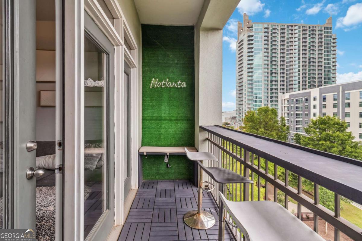 Experience upscale in-town living in this beautifully updated 2 bedroom, 2 bathroom condo located in the heart of Atlantic Station. Perched on the 6th floor, this spacious unit has been meticulously maintained. Key features include 10 foot high ceilings, abundant natural light, and a versatile layout ideal for relaxing and entertaining. The open-concept kitchen seamlessly connects to a bright kitchen equipped with stainless steel appliances, granite countertops, and light cabinetry. Adjacent to the kitchen, a flex room serves as a dining area or home office, whatever caters best to your lifestyle. The owner's suits flaunts a spacious walk-in closet and private balcony overlooking Linear Park. The second bedroom offers ample space and a spacious closet as well. Both bathrooms have modern fixtures and granite countertops. Additional highlights include 2 assigned parking garage spaces, luxury amenities, and walking distance to restaurants, shopping, and other entertainment within Atlantic Station.