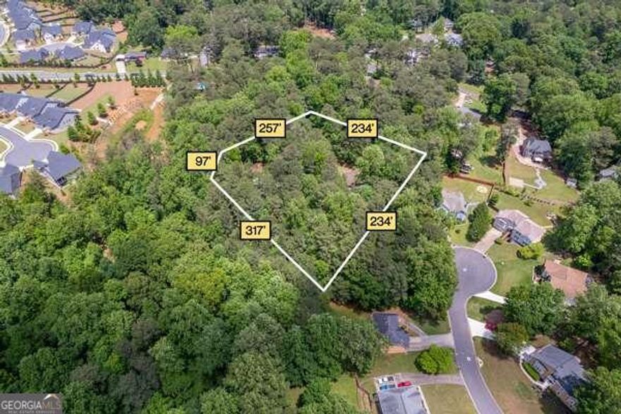 This property offers a rare opportunity to create your dream home or business on a sprawling, secluded 2.5-acre lot. Tucked away down a long driveway lined with tall trees, the lot provides a private, country-like setting, all while being conveniently close to major amenities. The possibilities are endless with this expansive, level lotCowhether youCOre looking to renovate the existing custom-built home, build a second residence, or establish space for a home-based business.  The current home features an open floor plan, where the great room fills with natural light and opens to a dining area and kitchen, creating a warm and inviting space. A large deck extends from the home, offering panoramic views of the serene, wooded surroundings. The upper level includes three spacious bedrooms, with the primary suite boasting a stone fireplace, trey ceiling, walk-in closet, and private deck with stunning views. An additional living area has been created from the converted garage, offering even more flexibility.  A substantial 1,600 sq. ft. barn/garage with electricity adds incredible value, serving as a perfect workspace, storage area, or garage for multiple vehicles. With ample parking and space to grow, this property is a rare find for those seeking both privacy and opportunity. Conveniently located near major routes like 285, it offers easy access to Marietta Square, Lockheed Martin, Smyrna City Center, and the Atlanta Airport. Sold As-Is, this is your chance to bring your vision to life in a prime location.