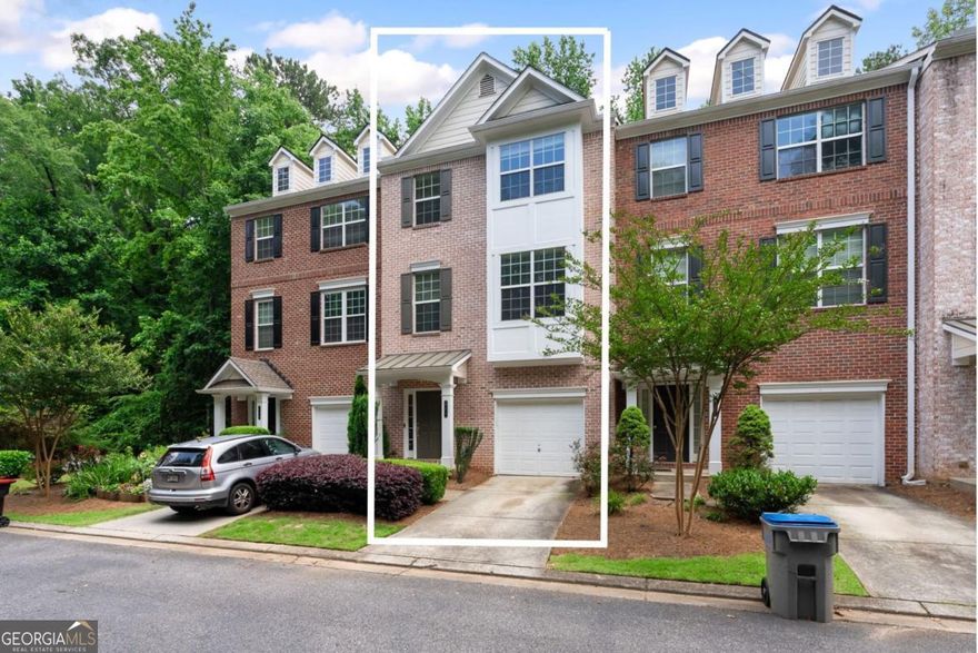 Freshly updated with brand-new carpet, this 3-bedroom, 3.5-bath townhome in the sought-after Cambridge community combines modern comfort with unbeatable convenience.  Step inside to find hardwood floors and a bright, open main living area that flows seamlessly into the updated white kitchen, complete with granite countertops and stainless steel appliances. The open floor plan sets the stage for both entertaining and relaxed evenings at home.  Upstairs, the spacious primary suite impresses with tray ceilings, a walk-in closet, and a primary bathroom featuring dual vanities, a soaking tub, and a separate shower. Each bedroom comes with its own private bath, offering flexibility and comfort for guests or roommates. The laundry is also located upstairs for easy access.  On the terrace level, you'll discover a versatile bedroom with two closets and a full bath-perfect for an office, guest suite, or second living area. This level also offers access to the back of the townhome.  Unwind outdoors on your private deck, where tree-lined views provide peace and privacy-no backyard neighbors! Additional features include a one-car garage, gated entry for security, and a prime location just one mile from Morgan Falls Park, close to Chattahoochee River trails, shopping, dining, and easy GA-400 access.  Move-in ready and thoughtfully designed, this townhome is the perfect fit for first-time buyers, professionals, or anyone seeking a low-maintenance lifestyle in the heart of Sandy Springs.