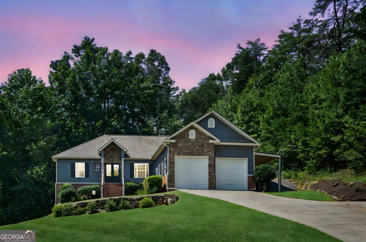 Discover privacy and convenience in this charming home at the end of a quiet cul-de-sac-just 6 minutes from Downtown Ellijay! PRIVATE Setting & Meticulously Maintained! Step inside to an open concept floor plan with spacious great room and soaring 9-foot ceilings, gleaming hardwood floors, and a cozy stone fireplace with gas logs-ideal for family gatherings or quiet evenings. The kitchen features granite countertops, stainless steel appliances, pantry and a seamless flow to the dining and living areas. The primary suite is a true retreat with a luxurious tile shower, indulgent jetted tub, double vanity, and an oversized walk-in closet. Two additional bedrooms on the main share a stylish Jack-and-Jill bath with herringbone tile. The finished basement is designed for FAMILY, FUN & FLEXIBILITY, offering a spectacular recreation room with a big screen TV for watching the big game, built-in bar, gaming area with pool table; a 4th bedroom, full bath, additional media room, office/workout room, and nice nook for a wine cellar completes the lower level. Fantastic outdoor living - Entertain or unwind in the private backyard oasis with a spacious deck, cozy firepit area, and relaxing hot tub under the stars. With a 2-car garage, high-speed internet, public utilities, all-paved roads, no HOA fees, and no community restrictions, this home delivers the best of mountain living with modern convenience. Embrace the serene lifestyle you've been searching for-all just minutes from Ellijay's vibrant shops, restaurants, vineyards and orchards. (Full time residents age 65 & older are eligible for school tax exemption.) SEE VIDEO & Virtual Walkthrough.