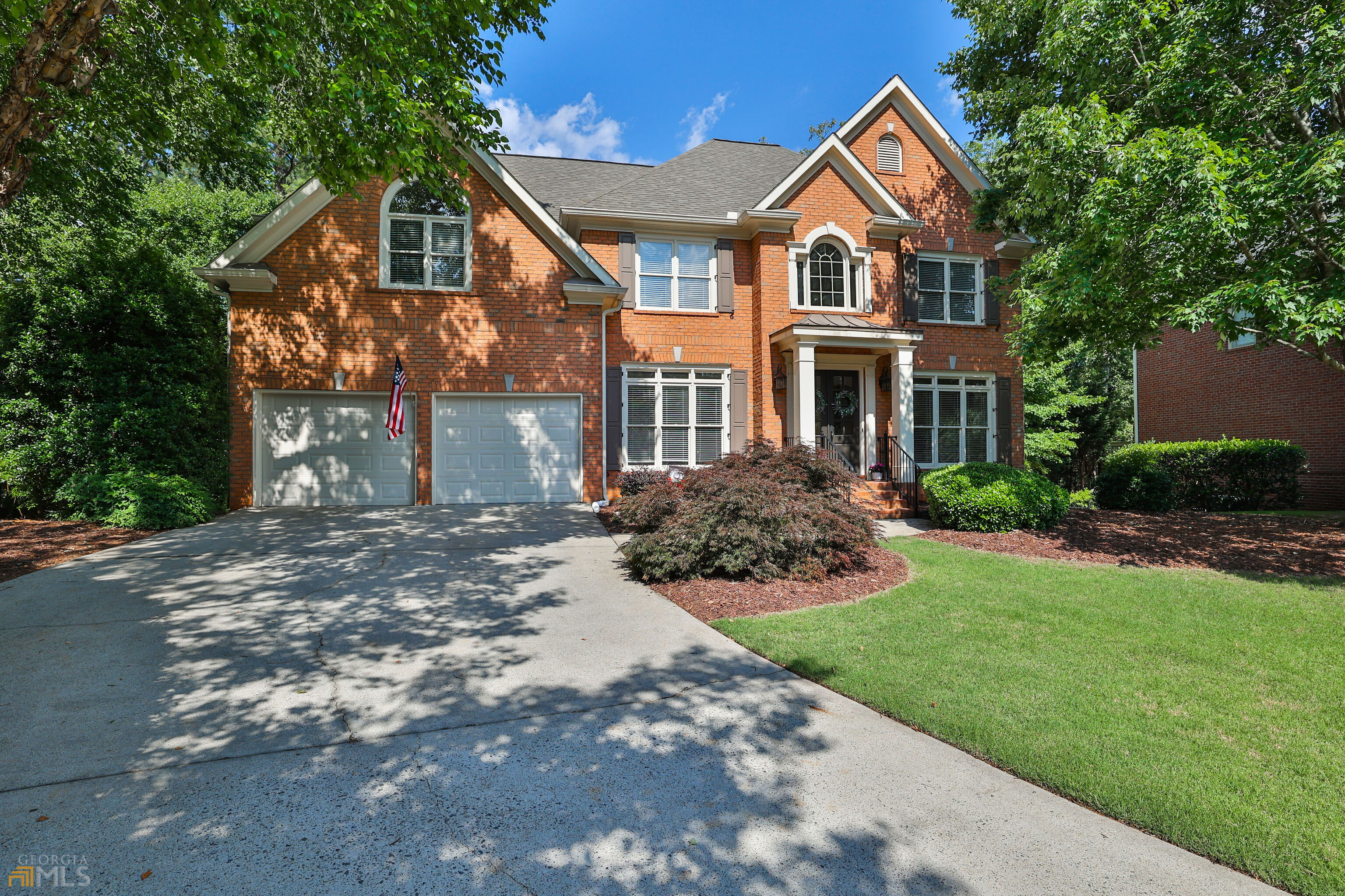 Fantastic opportunity to live in GATED ** 24 Hour Security** Laurel Springs Community, in TOP RATED Lambert High School, for under $1million. Laurel Springs is a gorgeous, quiet, gated neighborhood that has it all!! Swimming pools, tennis courts, gym, clubhouse, basketball court, playground, miles of sidewalks and a semi-private Jack Nicklaus Golf Course. The home is a 4 sided brick beauty that sits on a quiet double cul-de-sac street. Flat driveway and a large wooded backyard. Updated interior with new lighting, ceiling fans, faucets, and granite. Brand new, never used, frameless shower in master. Brand new garage doors and Craftsman belt drive openers. Brand new, never used, top of the line built in Kitchen Aid microwave. Viking refrigerator, Viking double ovens, Viking gas range top and Bosch dishwasher. New water heater. All 5 toilets have been newly replaced with Kohler. Neutral paint throughout the entire home. All hardwood floors on main. Neutral high end carpet upstairs. LVP flooring throughout terrace level. Walking distance to shopping and all three TOP RATED Forsyth County Schools!!!