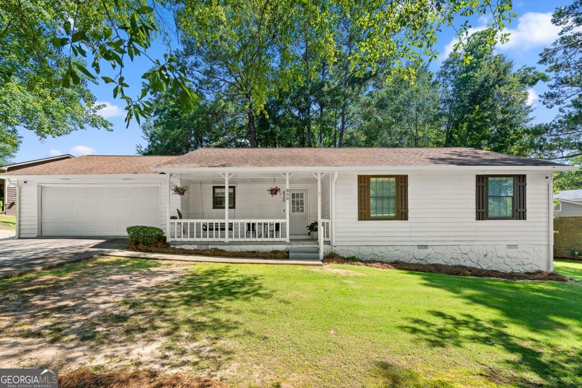 Welcome Home! Unbelievable RARE opportunity at an incredible price point. Well-maintained home. Amazing opportunity in stellar school district. Incredible convenience- minutes from I-85, Mall of Georgia, Coolray Field, Top Golf, & much more. Nestled in an established & quiet neighborhood with NO HOA. Greeted with charm & curb appeal- sprawling front yard and picturesque covered front porch. Comfortable one-level living. Home features newer oak-like LVP floors and a desirable open floorplan. Interior and exterior of home has been painted in recent years- showing owner's care. Septic in great condition with newer drain lines! Great room with updated LED lighting & fireplace. Open layout kitchen with solid wood cabinets and updated hardware. Stainless steel appliances. 3 well-sized bedrooms on main level. Primary room with an ensuite. The large fenced backyard is a true retreat-with a shaded canopy of mature trees. The covered back deck is ready for your finishing touches-screen it in or enjoy it as-is for relaxing evenings outdoors. Two-car garage, extended driveway & much more. Top-rated Mountain View High School district!
