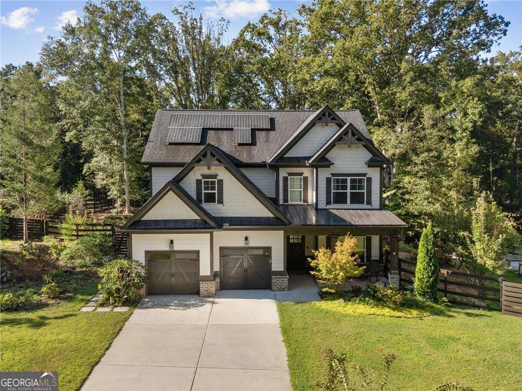 This charming farmhouse-style home blends timeless character with modern comfort, offering a private, low-maintenance lifestyle. From the inviting front porch to the tranquil rear covered patio, every detail is designed for effortless living and entertaining. Inside, hand-scraped hardwood floors and custom finishes create a warm welcome. The open kitchen is the heart of the home, showcasing high-end marble countertops, stainless steel appliances, and an oversized island that flows seamlessly into the fireside family room. French doors open to the covered porch, where you can relax year-round overlooking the sparkling custom pool and expansive, private lot. A flexible bedroom or office on the main floor provides options for guests or work-from-home living, while upstairs you'll find a serene primary suite, two spacious bedrooms, and an oversized rec room, perfect as a playroom, art studio, or home theater. Every room is beautifully proportioned, thoughtfully designed, and ready for move-in. Outdoors, the property is just as impressive. In addition to the pool and relaxing porches, there's a substantial storage building, large enough for a tractor, workshop, or hobby space. Meticulously maintained by its original owner, the home feels like new and is decorated to perfection with upgrades throughout. If you've been searching for a home that combines privacy, flexibility, and everyday ease, this one is move-in ready and waiting for you.