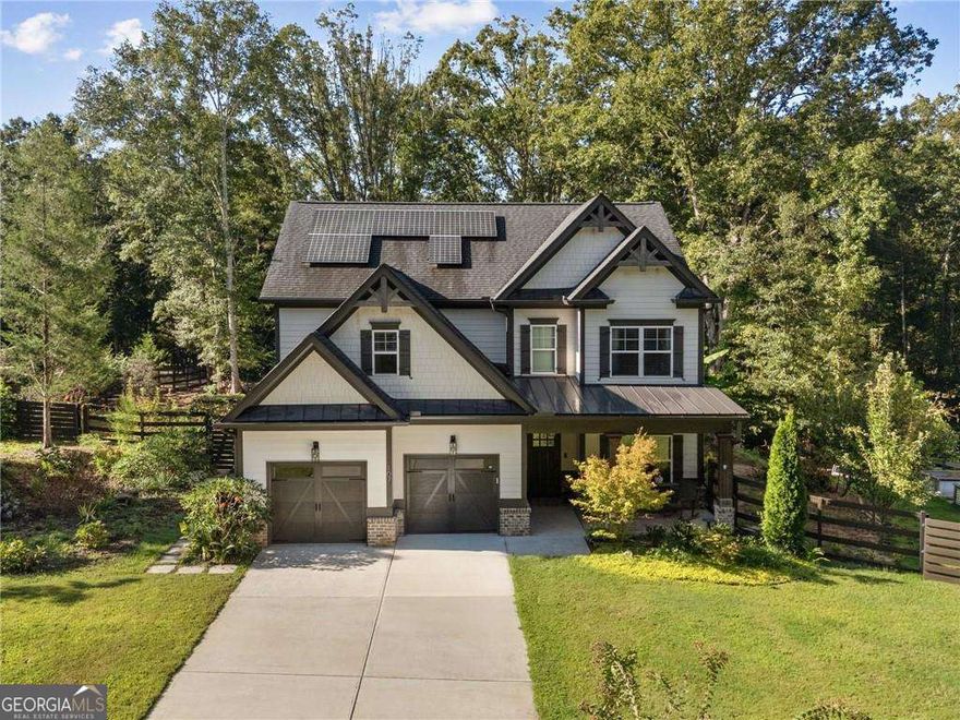 This charming farmhouse-style home blends timeless character with modern comfort, offering a private, low-maintenance lifestyle. From the inviting front porch to the tranquil rear covered patio, every detail is designed for effortless living and entertaining. Inside, hand-scraped hardwood floors and custom finishes create a warm welcome. The open kitchen is the heart of the home, showcasing high-end marble countertops, stainless steel appliances, and an oversized island that flows seamlessly into the fireside family room. French doors open to the covered porch, where you can relax year-round overlooking the sparkling custom pool and expansive, private lot. A flexible bedroom or office on the main floor provides options for guests or work-from-home living, while upstairs you'll find a serene primary suite, two spacious bedrooms, and an oversized rec room, perfect as a playroom, art studio, or home theater. Every room is beautifully proportioned, thoughtfully designed, and ready for move-in.    Outdoors, the property is just as impressive. In addition to the pool and relaxing porches, there's a substantial storage building, large enough for a tractor, workshop, or hobby space. Meticulously maintained by its original owner, the home feels like new and is decorated to perfection with upgrades throughout.    If you've been searching for a home that combines privacy, flexibility, and everyday ease, this one is move-in ready and waiting for you.