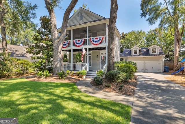 Welcome to this stunning home in sought-after Harrison Pointe - the one everyone wants to call home! With classic Craftsman charm and double front porches, the curb appeal is simply unmatched. Inside, the open-concept layout offers a spacious living and dining area that flows seamlessly into a chef's kitchen complete with pantry and a mudroom to keep everyday clutter at bay. Upstairs, you'll find a generous primary suite featuring a spa-like bathroom and private porch access, plus two additional bedrooms that share a well-appointed bath. Over the detached garage, a private guest suite with a full bath makes an ideal space for visitors, a home office, or in-law accommodations. Enjoy three inviting porches, a large front yard perfect for neighborhood gatherings, a private backyard retreat, and a two-car garage with additional parking space. All of this is located in one of the Island's most desirable communities-within walking distance to shops and restaurants and just minutes from everything else St. Simons has to offer.