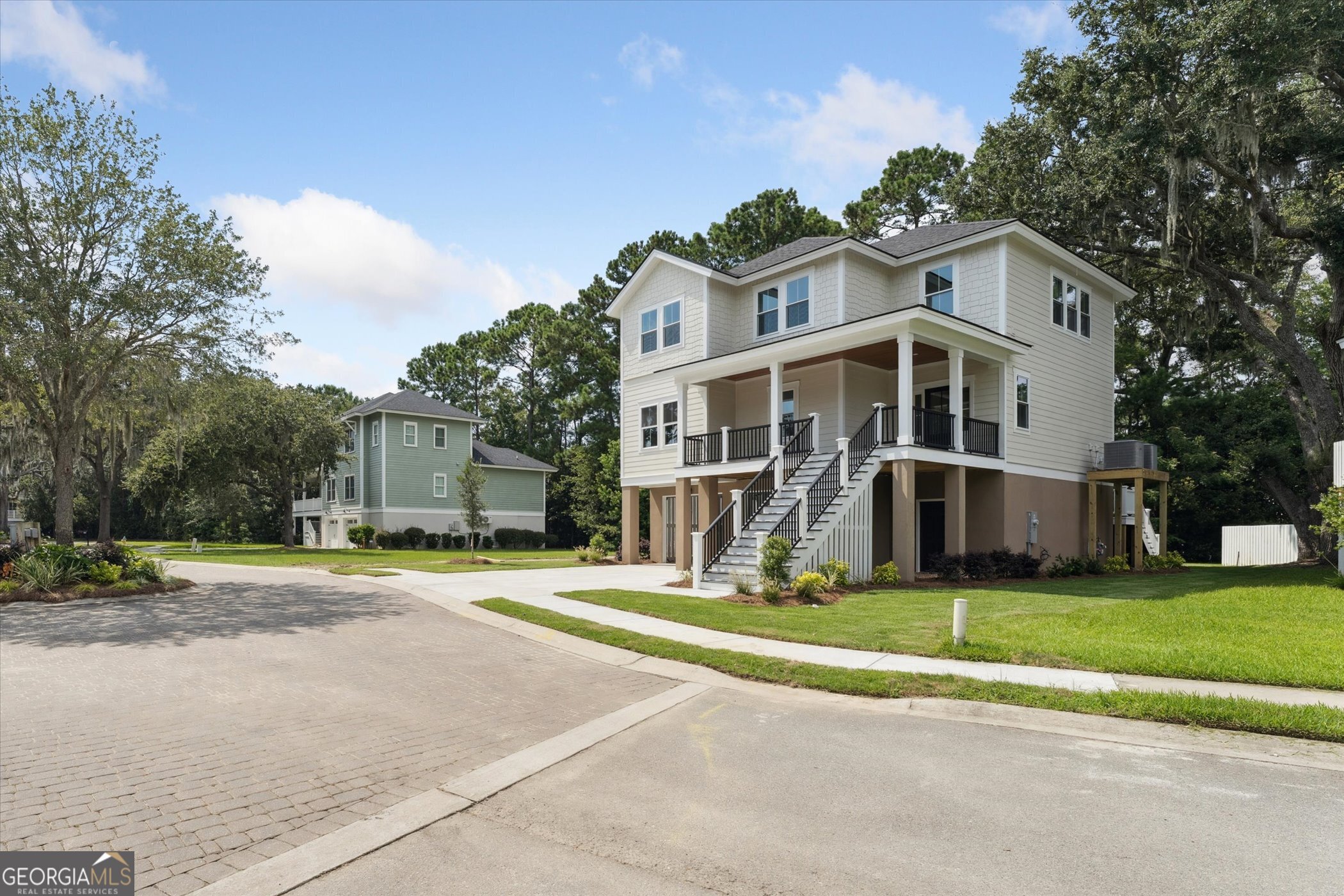 Located in Wilmington Island's desirable subdivision, Abby Oaks, this 4BR/3.5BA, 2,600 SF home showcases exceptional craftsmanship and upscale finishes throughout, including custom inset cabinetry. A welcoming front porch invites you to relax and enjoy peaceful Lowcountry mornings. Inside, the open-concept design features a spacious kitchen, dining, and living area with soaring ceilings, durable hard surface flooring, and detailed crown molding. The luxurious primary suite offers a spa-like bath with dual vanities and custom inset cabinets, a soaking tub, a separate shower, and a custom his-and-hers walk-in closet. Step out back to the balcony, perfect for entertaining or unwinding in the evenings. Additional highlights include a large upstairs laundry room, 2-car garage, tankless water heater, and a low-maintenance exterior with Hardie Plank siding and non-rot decking. Don't miss your chance to make this one-of-a-kind home yours!