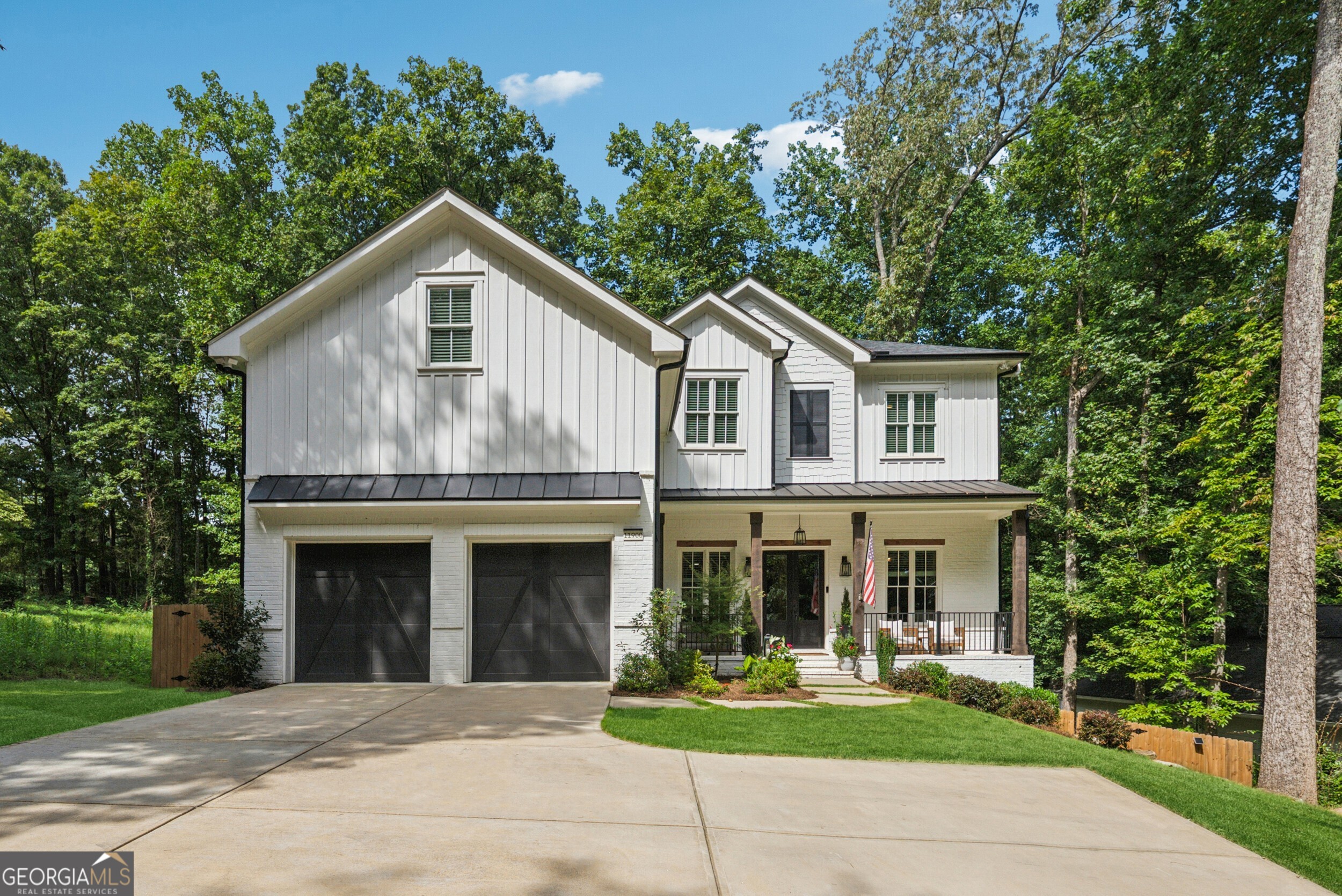 School district! Warm hardwoods flow throughout the expansive open floor plan, paired with a bright neutral palette that radiates warmth. Elegant wainscoting and refined trim throughout will delight you, adding a touch of timeless charm. The cozy living area, accented by an inviting fireplace and overlooking a serene wooded backyard, creates a positively chic space perfect for lively gatherings or quiet evenings at home. The chef's kitchen shines with a large island, sleek quartz counters, a stylish dry bar, and stainless steel appliances, ideal for whipping up your favorite meals or hosting festive get-togethers. Four spacious secondary bedrooms offer ample room for family, guests, or hobbies, while the stunning owner's suite boasts a huge walk-in closet with built-ins, an island, and a gorgeous ensuite featuring double vanities, a soaking tub, and a large shower for ultimate relaxation. In addition, there is a fantastic loft/bedroom that is perfect for a kid's playroom or office. A full, finished basement adds versatility with a bedroom, full bathroom, and cozy living area-perfect for movie and game nights or accommodating visitors. More than 5,700 sq ft of space, ready to be yours! You'll find idyllic suburban living within two miles of coveted Downtown Alpharetta, Avalon, and just minutes from local parks and shopping nearby, plus easy access to GA 400. Zoned for prestigious Milton High School, this home perfectly complements your lifestyle. Schedule your showing today and discover the life within Alpharetta you've been dreaming of!