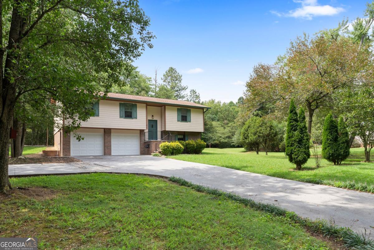 Welcome to the cutest 3 bedroom 2 bath home tucked away on a secluded .7 acre lot in Adairsville, GA. On the lower level, you will find a oversized room to be used as a 4th bedroom, playroom, office, or even a gym! This home is move in ready with all new paint, new carpet on stairs, new garage doors, and a new water heater. You will LOVE the private back yard! Peaceful living at its finest - run!
