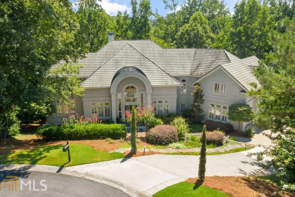 The Finest in Modern Living! Don't miss this rare opportunity to own this totally custom designed home.  The floating staircase, flanked by the dining room and study, invites you to enjoy the view of the outdoors from the wall of windows in the 2 story Grandroom that overlooks the pool. The heart of the home is the superbly appointed kitchen/breakfast are with new Wolf appliances, marble counters, fireside Keeping room and an amazing pantry. A complete guest suite and home theater room, round out the main level.  The upstairs features a magnificent master suite with recently remodeled, His/hers baths and closets and 3 spacious, ensuite bedrooms and a bonus room. A Terrace level welcomes you with high ceilings and a wet bar great for entertaining. Also included is the billiard room and exercise room that totally over look the pool/spa and the golf course.  Located in a gated, Country Club community and within walking distance to the newly constructed recreational facility with Water Slide, Jr. Olympic pool, Rec Center, Sports court and playground