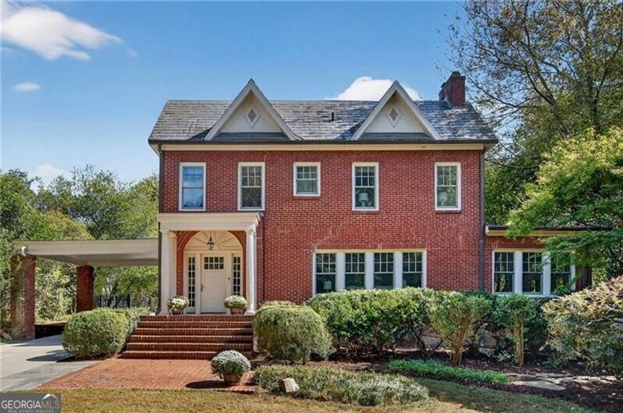 A rare offering in the heart of historic Druid Hills, this stately residence embodies the grace, scale, and quiet sophistication that define the neighborhood's most admired homes. Set far back from the avenue on over an acre of private, park-like grounds, its slate roof and timeless fa ade stand as a testament to enduring architecture and impeccable stewardship.  Every element feels intentional - from the tree-lined approach behind an automatic gate to the ample parking that welcomes with understated luxury. Inside, light and proportion take center stage. The grand foyer opens to beautifully scaled rooms that flow effortlessly from one to the next, creating a sense of ease and refinement that unfolds naturally throughout the home. Tall ceilings, rich millwork, and gleaming hardwoods honor the home's historic soul, while thoughtful updates infuse it with warmth and livability.  At the heart of it all, the chef's kitchen is both refined and functional - appointed with Sub-Zero refrigeration, soapstone and marble surfaces, and custom cabinetry that balance elegance with purpose. The adjoining gathering spaces invite connection, whether for quiet mornings or lively evenings among friends.  Upstairs, the primary suite offers a sense of retreat and repose, with a marble-accented bath that feels both classic and indulgent. Secondary bedrooms are generous and light-filled, complemented by a dedicated laundry room and extensive basement storage.  Beyond the main residence lies one of the property's most exceptional features - a beautifully finished guest house complete with a full kitchen, large bedroom, full bath, and half bath - perfect for guests, extended family, or a private studio retreat.  Outdoors, the experience becomes extraordinary. A spectacular heated pool with spa and cascading waterfall anchors the landscape - large enough for true lap swimming and surrounded by tranquil privacy. The setting feels worlds away, yet moments from Emory, Fernbank, and the city's finest dining and cultural destinations.  This is Druid Hills at its most refined: architecture with presence, grounds with purpose, and a lifestyle that balances historic beauty with modern grace. A home that honors the past while living effortlessly in the present - elegant, enduring, and unmistakably rare.