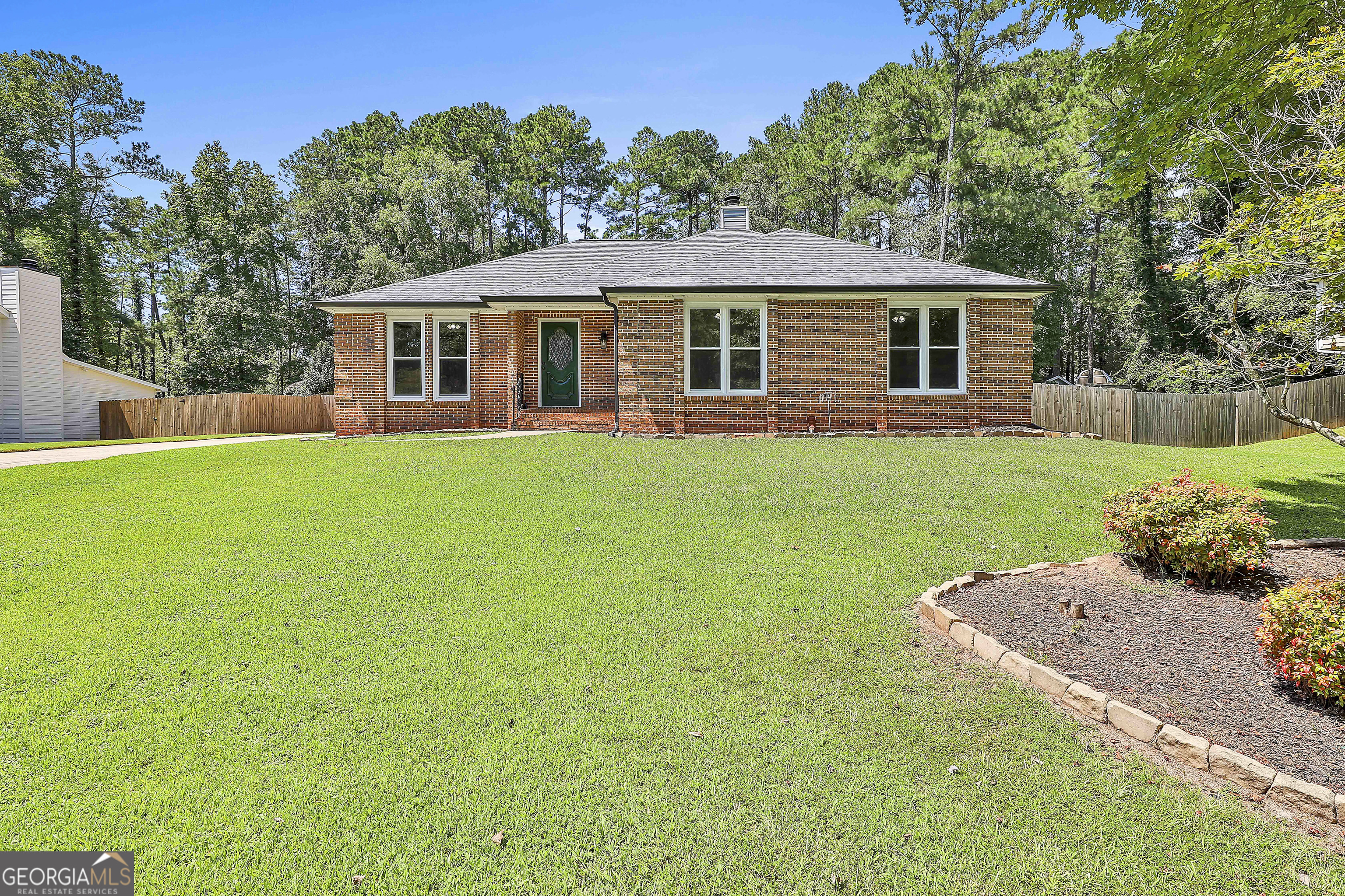 Brick front RANCH in a prime Peachtree City location! this well-maintained 3 bedroom, 2 bath ranch home is neat as a pin, ideally located in the heart of Peachtree City, just minutes (or a golf cart ride) from shopping, great schools, dining, and entertainment. recent updates include: new granite countertops and backsplash (2025), new oven/range (2025), new windows (2023), new roof (2021), newer LVP flooring (2020), newer AC unit (2019), new vinyl siding, new privacy fence (2023), newer garage door (2022), updated lighting, and new electrical panel (2025). The comfortable, spacious layout features a large living room with a gas fireplace and wet bar, a roomy kitchen with ample cabinet storage and plenty of room for an island, separate dining room (or office/flex space), a breakfast area with a dramatically designed beamed vaulted ceiling, a large, separate laundry room, a large primary suite with an updated shower, dual vanities and two closets, and two additional bedrooms with a shared full bath. Outside you will find a private, fenced backyard with a fire pit and room for a garden, a large patio, a solar-powered cooled chicken coop, storage shed, and a large, side entry two car garage. This home combines location, comfort, and value-ready for its next owner!