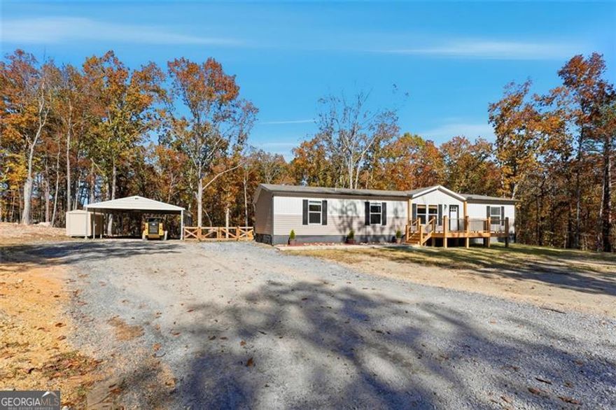 Welcome Home to 158 Woodsmoke Rd, Rockmart, GA! This beautiful 2021 Clayton "Morocco" 4-bedroom, 2-bath manufactured home sits on a permanent block foundation on 4.8 private acres, offering the perfect blend of modern comfort and peaceful country living. Inside, enjoy an open-concept layout with a bright living room, stylish kitchen featuring a large island and stainless-steel appliances, and a dining area ideal for gatherings. The owner's suite includes a spacious walk-in closet and a bath with a soaking tub and shower combo, while three additional bedrooms and a full hall bath provide plenty of space for family, guests, or a home office. Well-maintained and move-in ready, this home features durable sheet vinyl flooring, neutral colors, and energy-efficient construction. Enjoy quiet rural living just minutes from downtown Rockmart, local schools, and shopping. Title retired to land - qualifies for FHA, VA, and USDA financing!