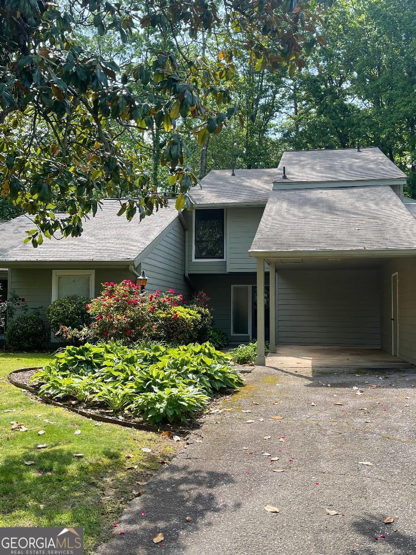 Prime location, spacious, sunlit condo located in a small, private enclave of townhomes on a cul-de-sac street in an excellent school district, and minutes from shopping, GA400 highway, malls, restaurants, Northpoint Mall, popular Avalon, downtown Alpharetta with its trendy shops, restaurants and entertainment, and Ameris Bank Amphitheater. The main level features a living room with fireplace, dining area, kitchen with breakfast bar, window over sink and white cabinets, family room, laundry room, a guest bath, and private patio. On the second level you will find three bedrooms and two bathrooms, and a walk-in closet in the primary bedroom. The vaulted ceilings, and many windows allow light and a feeling of spaciousness throughout, and ample closets/storage. The carport has an adjacent storage room, and the driveway accommodates guest parking. This sought-after location is in an area of higher-value homes, and endless conveniences. The community pool provides the opportunity for relaxation, fun for the kids, and socializing with neighbors.