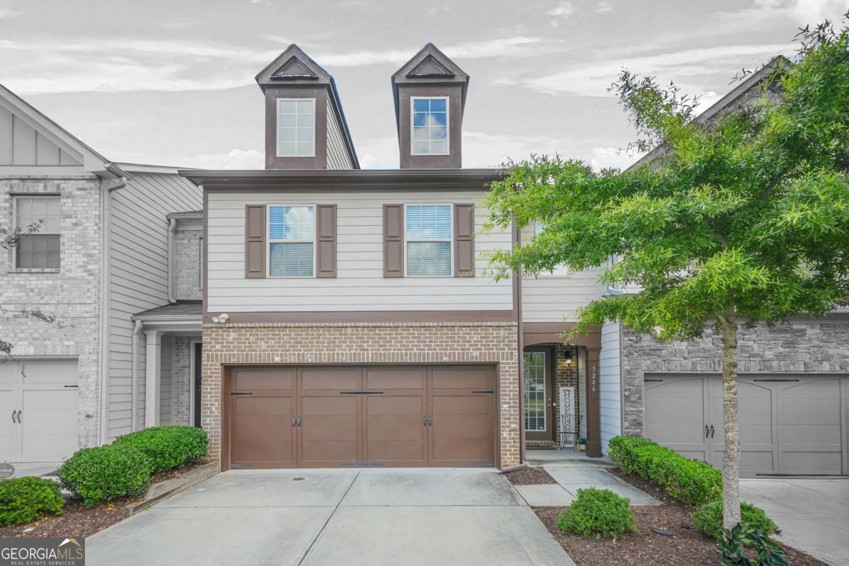 This stunning 3 bedroom, 2.5 bath townhome offers modern living with a bright, open floorplan and designer touches throughout. The main level features hardwood flooring, a spacious fireside family room, and a stylish kitchen complete with granite countertops, a large island, and ample cabinet space - perfect for everyday living and entertaining. Upstairs, enjoy a versatile oversized loft ideal for a second living area, home office, or cozy sitting room. All three bedrooms are located on the upper level, including a spacious primary suite with a walk-in closet and private bath. Two additional bedrooms and a full bath complete the upper level. Step outside to your own private fenced backyard featuring low-maintenance turf - a perfect space for pets, play, or gatherings with family and friends. Community amenities include a swimming pool, tennis courts, and a clubhouse. Conveniently located just minutes from Stonecrest Mall, Stone Mountain Park, shopping, dining, and major highways. Schedule your showing today - this gem won't last long!