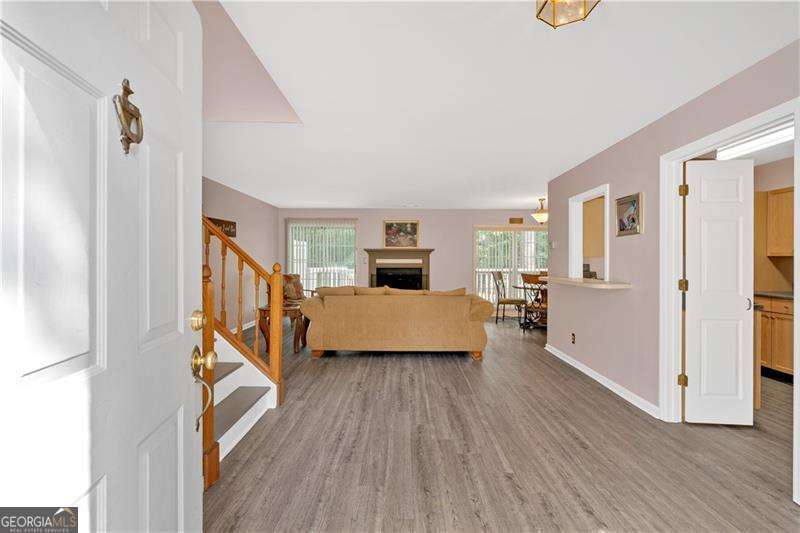 Welcome to this lovely ground level entry 2 bed 2.5 bath townhome nestled in the heart of Smyrna. This open floor plan has LVP flooring throughout most of the home! Beautiful kitchen featuring wood cabinets and separate dining area. Large living room with fireplace and plenty of natural lighting. The master bedroom has a vaulted ceiling, walk-in-closet and includes an en suite bathroom with double vanities. Relax on your private back deck overlooking the woods. Home is located within minutes of Truist Park & The Battery, Cumberland Mall and the Silver Comet Trail. Conveniently located close to both 285 and 75. This one will not last long!