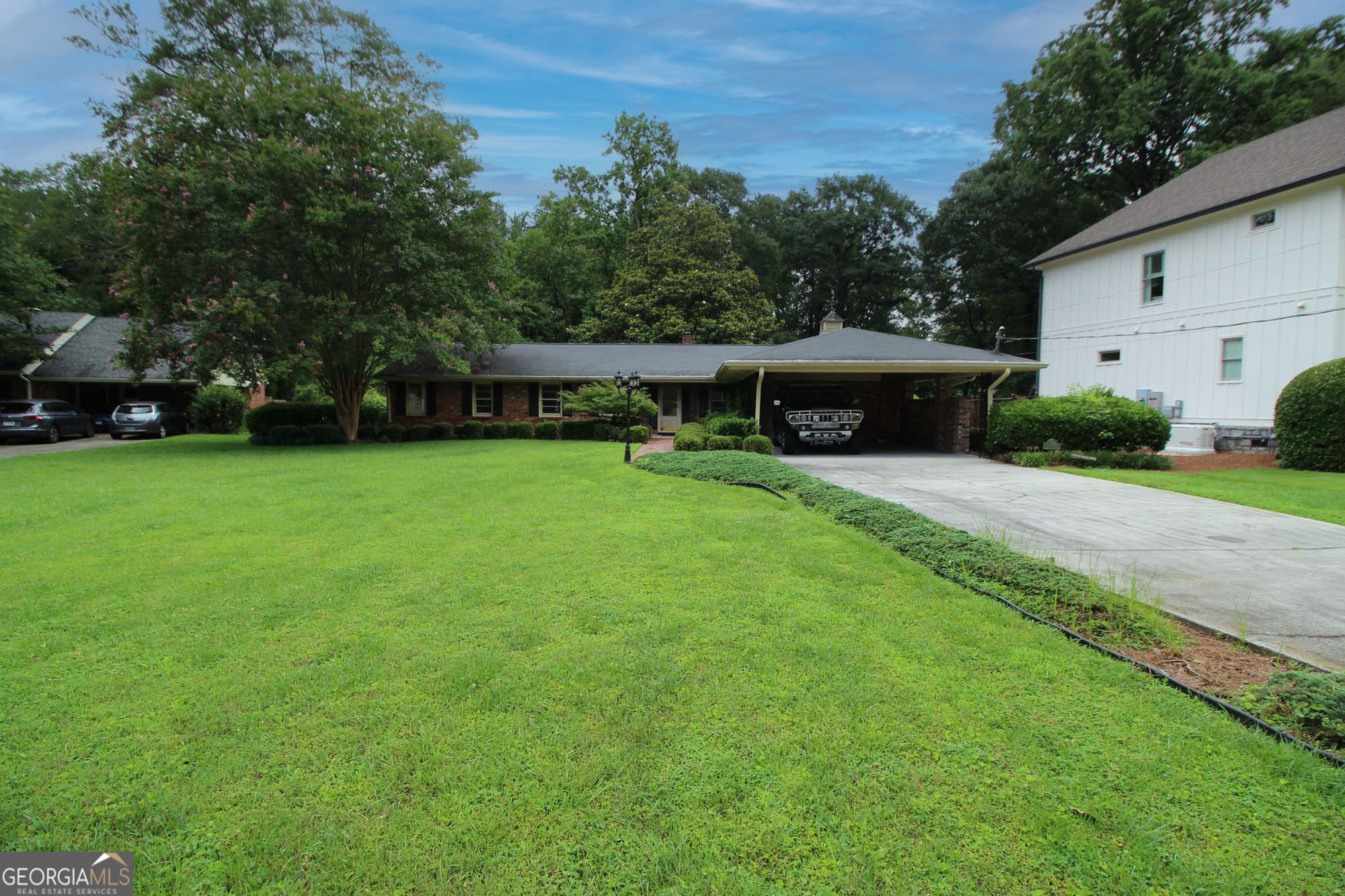 Charming All-Brick Ranch on a Peaceful Cul-de-Sac in Sought-After Starlight Hills. Step into timeless comfort and potential with this solid 4-bedroom, 2-bath ranch home, nestled on a generous half-acre level lot in Starlight Hills, one of Sandy Springs' most desirable neighborhoods. This home offers a rare combination of privacy, charm, and convenience, perfect for your forever home or next renovation project. Highlights 1) Unbeatable Location - Located inside I-285 off Peachtree Dunwoody Road between Buckhead and Perimeter Center. Enjoy Super Close Proximity to the Path400 Greenway and future Sandy Springs Trail - ideal for biking, jogging, and community connection. 2.)Spacious & Private Lot - Zoned RD-18 (Residential Detached), this half-acre flat lot features mature trees and a private backyard bordered by Nancy Creek (not in a flood zone). One of the largest and flattest lots in the area! 3) Solid 4-Sided Brick Ranch - Built to last with hardwood floors, 4 true bedrooms, 2 full baths, a classic masonry fireplace with gas line, and a welcoming, functional layout. 4) Flexible Living Space - Includes an eat-in kitchen, formal dining room, comfortable living room, and a cozy den that opens to a large walk-out patio - ideal for outdoor entertaining. 5) Ample Storage + Workshop - Rare extras include a floored attic, two interior storage rooms, and a detached workshop - perfect for hobbies, tools, or storage. Selling As-Is - Bring Your Vision This home has great bones and curb appeal with potential to renovate, expand, or simply update to your taste. Whether you're a homeowner or investor, this is a fantastic opportunity in a stable, high-demand area.
