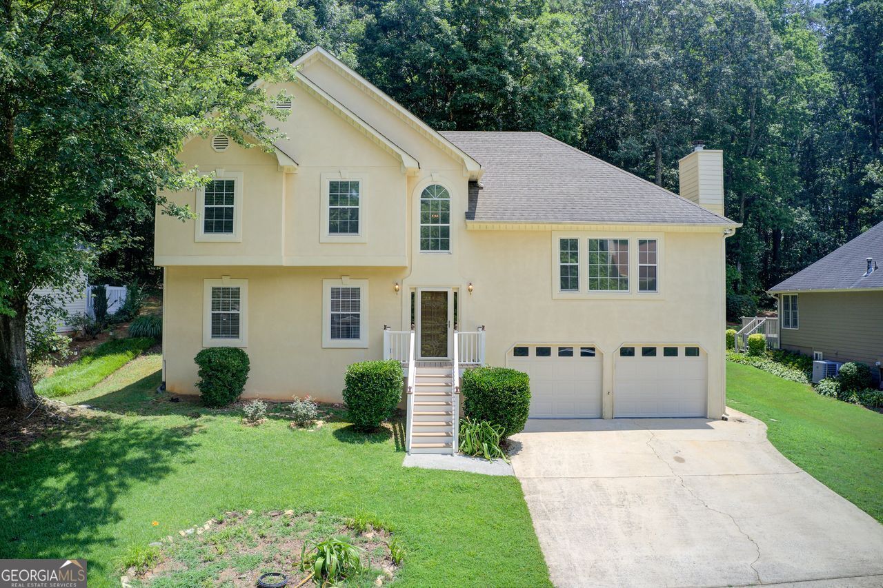 Welcome to Your Dream Home! This beautiful property truly has everything you've been looking for-comfort, space, and an unbeatable location just minutes from Bells ferry Rd, I 575, I-75 and charming downtown Woodstock. The main level features a spacious open floor plan filled with natural light and highlighted by a cozy fireplace. The expansive dining room flows into a beautifully renovated kitchen with granite countertops, ample cabinetry and an eat-in area that open directly to serene patio. The oversized primary suite offers a large walk-in closet and luxurious full bath with double granite vanity. Upstairs you'll find two additional generously sized bedrooms and full bath. One of the standout features of this home is the fully finished in-law suite, complete with a full kitchen, full bath and private access from the backyard. Don't miss this rare opportunity to own a move-in ready home in prime location!