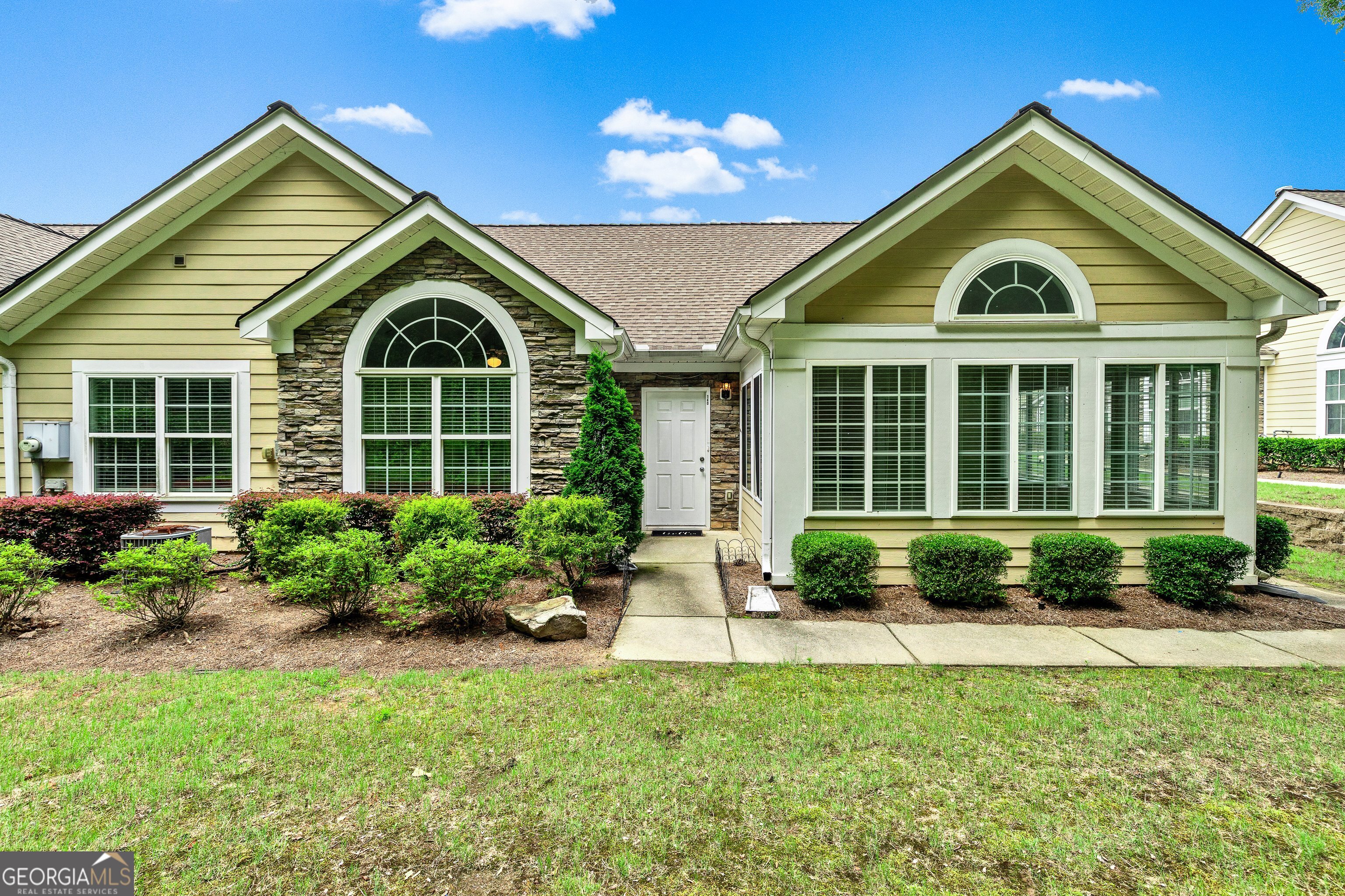 OPEN HOUSE, Sunday, 6/15/2025, 1P - 4P * WELL-MAINTAINED, step-less RANCH located in easy-living 55+ community! This spacious home offers 1,838sqft with 2 bedrooms, 2 FULL bathrooms, a dedicated office -which could be another bedroom- and a bright, airy sunroom with LOTS of windows - perfect for natural-light enthusiasts * The open-concept layout showcases a cozy living space with a gas-log fireplace that flows seamlessly into the dining and kitchen areas-perfect for everyday living and entertaining * Other home amenities and improvements include easy-access, WALK-IN BATHTUB in the guest bath * Newer water heater & windows -replaced approximately one year ago- and a newer garage door opener * Paint just refreshed & carpets professionally cleaned * Community amenities include yard care in addition to clubhouse with kitchen and pool table * Residents also have the opportunity to enjoy the workout area & outdoor pool * Conveniently located near Trilith and a variety of shopping, dining, and healthcare options, this home combines comfort, style, and accessibility