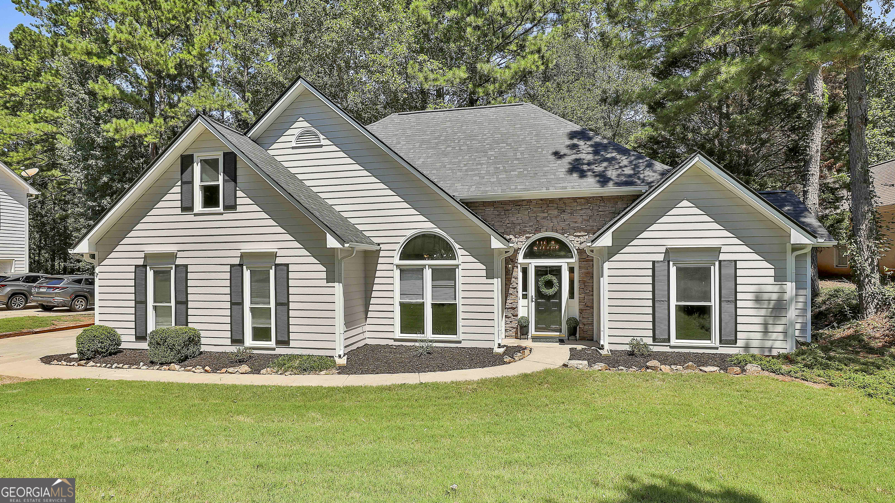 DO NOT MISS this rare opportunity to own a home in the highly sought-after Planterra Ridge community in beautiful Peachtree City! This 4-bedroom, 2.5-bath home offers key updates already done for you: brand new roof (Aug 2025), freshly painted exterior, 3-year-old HVAC system, windows and water heater are 6 years old. Step inside to an open and flowing floor plan featuring a welcoming foyer, guest bath, formal dining room, and a vaulted great room that seamlessly connects to the updated kitchen and breakfast area. You'll love the coffee nook, laundry room, and spacious pantry. The kitchen is the heart of this home with its granite-topped island, tile backsplash, and stainless steel appliances. The primary suite on the main level boasts a bay window, private patio access, and a light and bright bathroom with a garden tub, dual-sink vanity, separate shower, private toilet, and a large closet. Upstairs, you'll find three additional bedrooms with ample closet space and a full hall bath. Outside, enjoy your fully fenced backyard and rear patio-perfect for relaxing or entertaining. The home also includes a 2-car garage PLUS a separate golf cart garage. Living in Planterra Ridge means enjoying top-notch amenities: Lake McIntosh access, a members-only swimming pool, sports court, volleyball court, playground and sidewalks. And with Peachtree City's golf cart lifestyle, you're just a short ride away from shopping, dining, and fun! This home is ready and waiting for YOU to call it HOME!