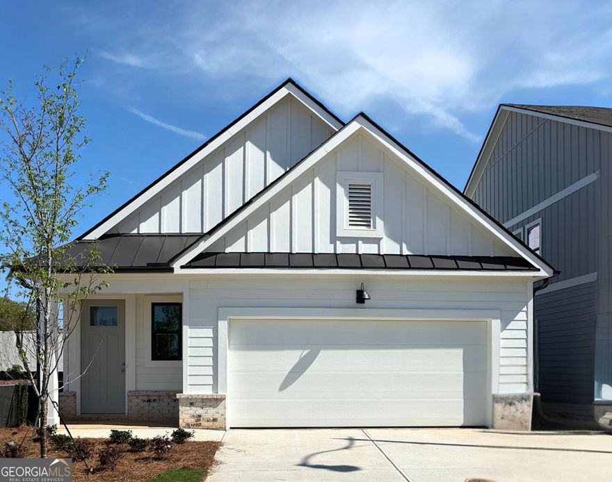 This captivating 1.5 story Bowen floorplan is nestled in the highly sought-after East Cobb area. Be one of the first homeowners in this prestigious community! Incredible open floor plan with the kitchen overlooking the dining and family room perfect for entertaining. The Bowen plan features a chef inspired gourmet kitchen w/ a island, Stainless steel appliance, quartz countertops and appliance package that includes an oversized cooktop, wall oven, wall microwave, custom wood hood complete with Revwood flooring throughout the main living spaces. Bedroom one and bedroom two are conveniently located on the main. Off the family room you will find a rear covered patio for outdoor living and front entry two-car garage. The upstairs features an additional bedroom and full bath with large walk in closet. This gated community features paver lined roads and amenities including pool, clubhouse and pocket park for residents' enjoyment. In addition to its tranquil and picturesque setting, homeowners will enjoy ease-of-access to Hwy 75 with, close proximity to shopping and eateries in Marietta as well as nearby trails and parks.