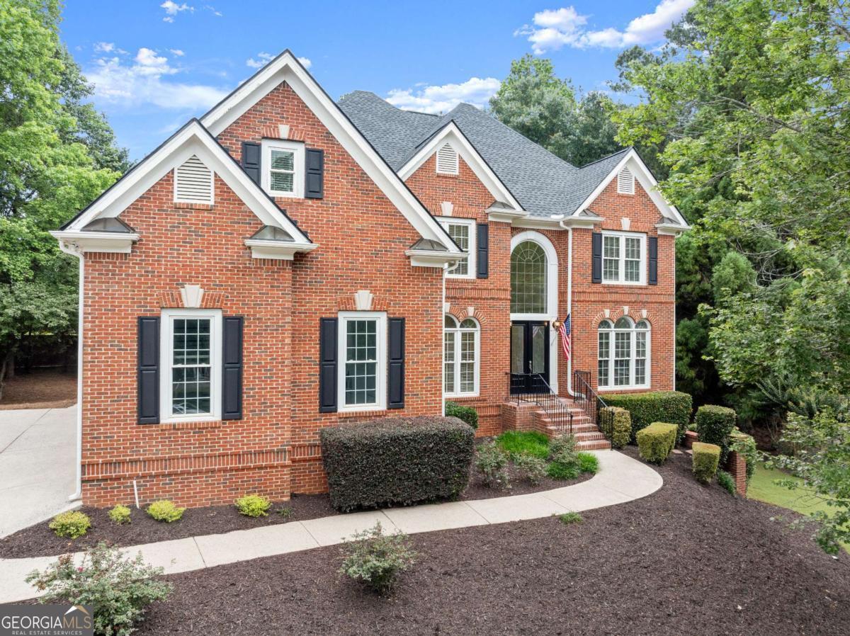 New on the Market! Nestled within Crooked Creek, Milton's most coveted gated community, this exceptional six-bedroom residence embodies elegance, comfort, and top-tier amenities. Inside, this move-in-ready brick home is newly refinished hardwoods, a stunning two-story foyer, and a sun-drenched family room with floor-to-ceiling windows, a gas fireplace, and custom bookshelves. The chef's kitchen is a masterpiece with stainless steel appliances, granite counter, a gas stove, and a welcoming breakfast nook. The oversized owner's suite offers a private sitting area, tray ceilings, a cozy gas fireplace, and a spa-like bathroom with a spacious walk-in closet. The finished terrace level elevates the living experience with a theater room wired for surround sound, a game/additional family room, a full bedroom/bath suite, a workshop space, and a private office with exterior side entry. Completing the home is an oversized three-car garage and a private backyard featuring a large deck for entertaining, a zoned irrigation system, and a garden area. Residents enjoy 10 lighted tennis courts and 4 pickleball courts, with top ALTA teams. The neighborhood also boasts a swim team, basketball court, playground, and an elegant clubhouse with catering kitchen and event space, ideal for private gatherings. Beyond the amenities, this home is zoned for top-rated Cambridge High School, offering exceptional educational opportunities. Its prime location provides quick access to Halcyon, Avalon, Downtown Alpharetta, and GA 400, ensuring seamless connectivity to premier shopping, dining, and entertainment. This home delivers the ultimate combination of luxury, convenience, and community-centered living -an unparalleled opportunity in Milton's most desirable neighborhood.