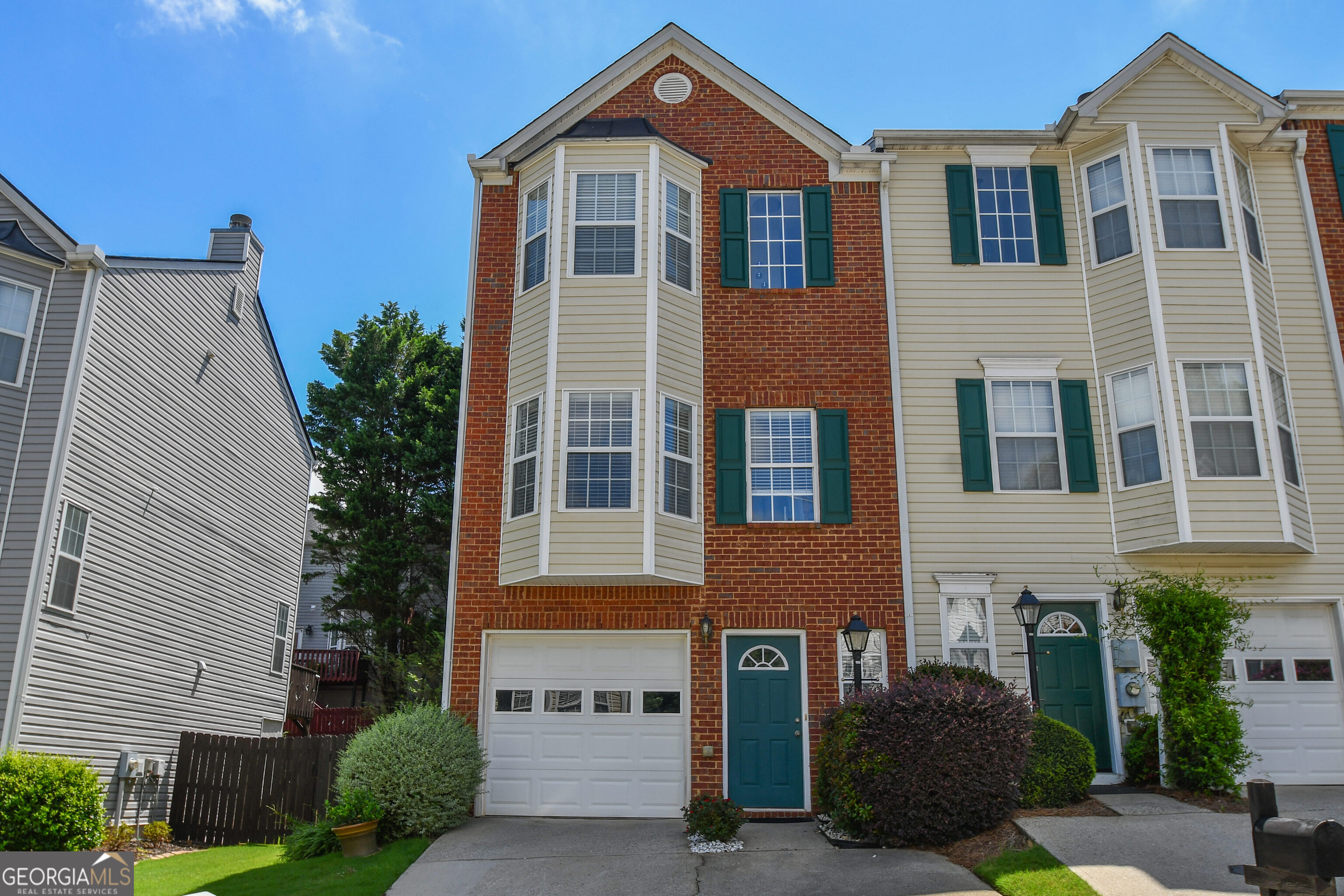 Welcome to this beautifully maintained 2-bedroom, 2.5-bath end-unit townhome located in a quiet and desirable community near downtown Cumming. This move-in ready home offers an attached garage plus extra parking, making everyday convenience a breeze. The kitchen features stained cabinets, a breakfast bar, and a spacious dining area-perfect for hosting or enjoying family meals. Relax in the large family room with a cozy gas fireplace, ideal for quiet evenings or entertaining guests. Upstairs, you'll find two generously sized bedrooms in a great roommate-style layout, each with their own private bath and walk-in closets. Step outside to a large deck just off the kitchen, overlooking a private backyard-a perfect spot to unwind or enjoy your morning coffee. This townhome is located in a well-kept community just minutes from schools, shopping, dining, and entertainment. With easy access to downtown Cumming, GA-400, parks, and more, this is an unbeatable location to call home!