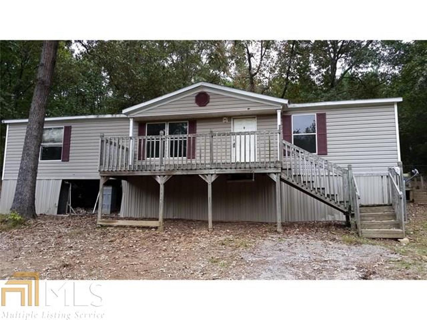 This is a wonderful 3 acre property with large circular driveway, county water and 3 bed 2 bath doublewide home. The home is a 2001 Fleetwood Eagle Trace and is in structurally good condition but will need some subfloor reapirs in the master bath, carpets, appliances and HVAC. Seller is offering Owner Financing on the home as is to qualified buyers. Seller may consider some repairs if purchaser is paying cash or has outside financing.