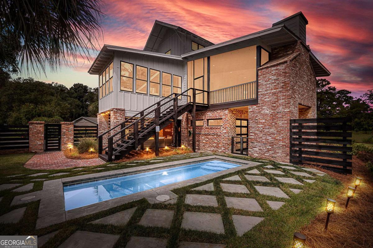 https://youtu.be/TIvT_jcSjEU Welcome to Island Escape! At Fern, one will find boho chic meeting coastal modern in this stunning south-end island residence. Located minutes to the beach in one of St. Simons' most loved neighborhoods full of live oaks and draping moss! Built in 2016 and situated on almost 1/2 acre, the design is not only smart with new 15 Seer Hvac, but throughout you will find everything to be natural, organic, colorful, and detailed.The smart and spacious plan features a primary suite on main with oversized closet and light-filled open living/kitchen design and a split bedroom plan upstairs. The lofty screened porch with gas fireplace overlooks rear yard with heated salt-water pool and is a relaxing and private all-weather retreat. The pool level is built for fun and includes a climate controlled flex space perfect to outfit as a workout room, lounge area, office or 4th BR & includes a convenient full bath ok for wet feet! Covered parking has large storage room for bikes & beach gear. Thoughtful details include feature walls w/reclaimed wood, gorgeous granite, high-end finishes and main level laundry room. This home is truly turnkey and being sold completely furnished. A charming island retreat just 1.6 miles from the sandy shores of Saint Simons Island! This coastal gem offers the perfect blend of comfort, convenience, and investment potential. Whether you're searching for a full-time residence, a second home, or a short-term rental opportunity, this property checks every box. Located in a quiet, established neighborhood with no HOA, you'll enjoy easy access to the beach, shops, dining, and all the charm the Golden Isles has to offer. Don't miss your chance to own a slice of island life with strong rental income possibilities!