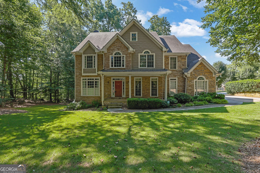 Rare 5BR Updated Home in Prestigious Arnold Mill Estates with In-Law Suite & Ultimate Privacy! This is your chance to own a meticulously maintained 5-bedroom home in the sought-after Arnold Mill Estates community. Situated on a serene .92-acre lot that backs up to Berry Patch Farms, this home offers exceptional privacy and peaceful views. Inside, enjoy a welcoming 2-story foyer, gleaming hardwood floors throughout the main level, and an open floor plan that provides seamless flow and functionality-perfect for everyday living and entertaining. The eat-in kitchen is a chef's dream, featuring granite countertops, double ovens, and plenty of space to gather. The oversized master provides a separate sitting area with Fireplace to allow for a true private suite. The finished basement includes a complete in-law suite, offering flexibility for multi-generational living or guest accommodations. A spacious 3-car garage adds to the convenience of this move-in-ready property. Enjoy access to Downtown Woodstock, shopping, restaurants, parks and top rated schools in this exclusive neighborhood!