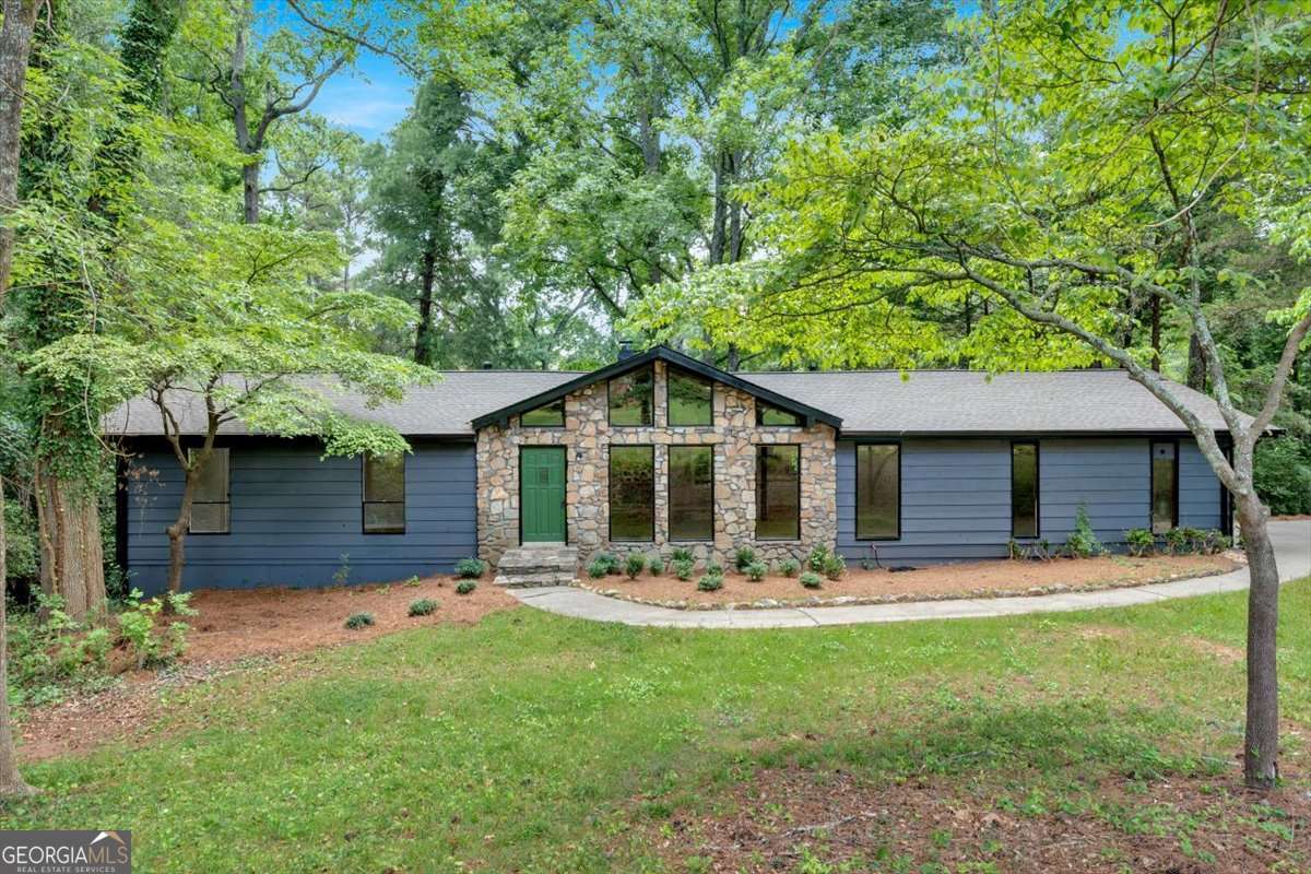 A recently renovated ranch home located in the Brookwood School District. From the minute you enter this home, the open floor plan will feel just like home. The open floor plan flows from the eat in kitchen, family room, large dining room and the cozy fireplace seen from this entire area. The floor plan showcases a spacious area that caters to easy entertaining. The kitchen offers butcher block countertops, a breakfast area, perfect for casual dining with a view! For the owners convenience, the laundry room is on the main floor as well as the garage entrance allows you to walk right into the kitchen with minimal steps. Beyond the open floor plan, you will find the owner's suite with a large closet and a private ensuite bathroom with a tiled Shower. Two additional spacious bedrooms share a well-appointed hall bathroom. The unfinished basement complete with a full boat door, 3rd garage space, and plenty of additional room to finish to your needs. Stepping outside, you have a corner lot and near by cul-de-sac with mature trees and a flat driveway. This gorgeous home has an incredible location that is convenient to highways and the Brookwood School District. Don't forget, the historic downtown Lilburn's is close by for shopping, dining along with Gwinnett County parks. Make an appointment to see this great home today.