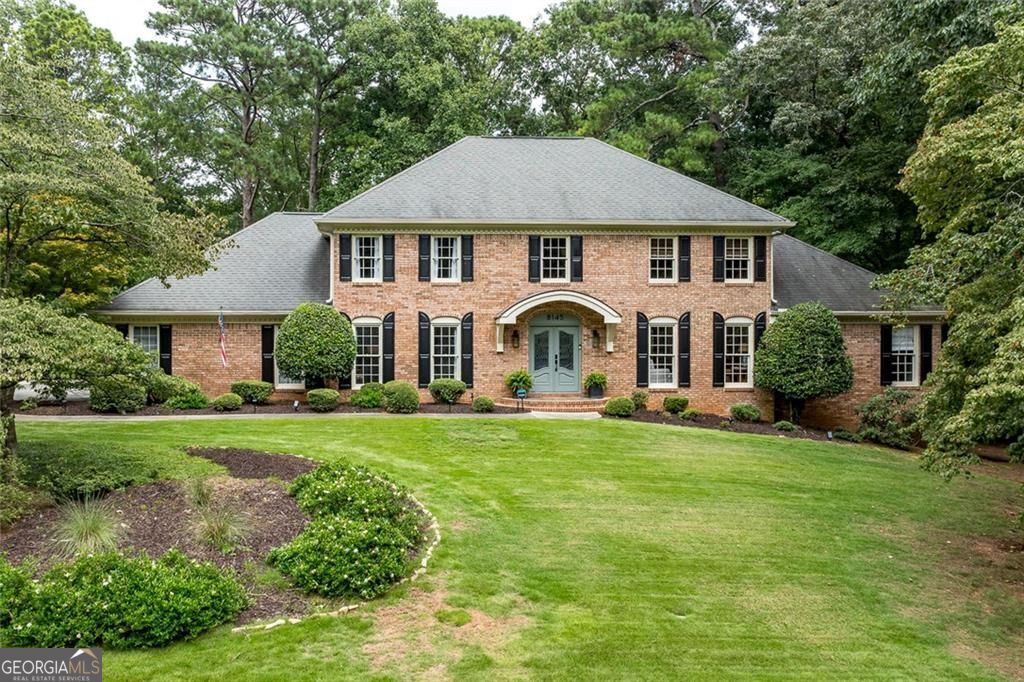 Exquisite All-Brick Masterpiece in Prestigious Rivergate! Welcome to this stunning, move-in ready home, perfectly situated on a beautifully landscaped 1.2-acre lot in the highly sought-after Rivergate neighborhood. Impeccably maintained and boasting a spectacular renovation, this all-brick residence offers timeless elegance, modern luxuries, and exceptional attention to detail. Step into the breathtaking two-story marble entry foyer, where natural light pours in and gleaming hardwood floors lead the way to a gracious living room with custom built-ins and a formal dining room. The newly renovated chef's kitchen is a true showpiece, where the dining room flows seamlessly into a light-filled space featuring crisp white cabinetry, marble countertops, subway tile backsplash, and a large center island with breakfast bar. Top-of-the-line stainless steel appliances include a professional-grade gas range with pot filler and a microwave/convection oven, creating both beauty and function for everyday living and entertaining. A charming farm sink, bright breakfast area, and spacious walk-in pantry complete this culinary haven. The inviting, paneled family room is accented by a beamed ceiling, built-in bookcases, and a brick fireplace, with French doors opening to a slate patio that overlooks the private, wooded backyard-an ideal setting for outdoor entertaining or peaceful relaxation. The main level also hosts the luxurious owner's suite, offering a serene retreat with a spa-like bath featuring dual marble vanities beneath a natural-light-filled skylight, a glass-enclosed shower, and a large walk-in closet. Rounding out the main level is stylish half bath for guests. Upstairs, a spacious landing connects to an additional primary suite with a beautifully renovated bath showcasing a dual vanity, frameless glass shower, and free-standing soaking tub. Two generously sized secondary bedrooms share a gorgeous hall bath. The spacious daylight terrace level expands your lifestyle possibilities with a game room, media area, office space, half bath, large laundry room, and abundant storage. Perfectly located in the Sandy Springs/Dunwoody area, this exceptional home offers convenient access to top-rated public and private schools, premier shopping and dining, recreational destinations including Dunwoody Country Club and Golf Course, and major interstates-placing all that Atlanta has to offer right at your fingertips. A perfect blend of timeless design, modern updates, and an unbeatable location-ready to welcome you home.