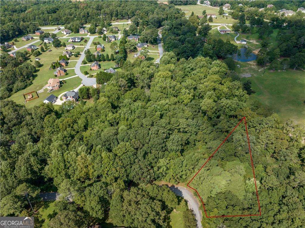Presenting a rare opportunity to own a private 3/4 acre +/- acre lot in Hidden Hills subdivision. This serene parcel of land is very scenic. The lot provides ample space for your vision. Nestled in the back part of Hidden Acres, it offers beauty and privacy. The land is gently sloped overlooking a peaceful creek at the bottom. It's a perfect blend of nature and community, providing both tranquility and convenience. Come check it out. The owner has soil tests.