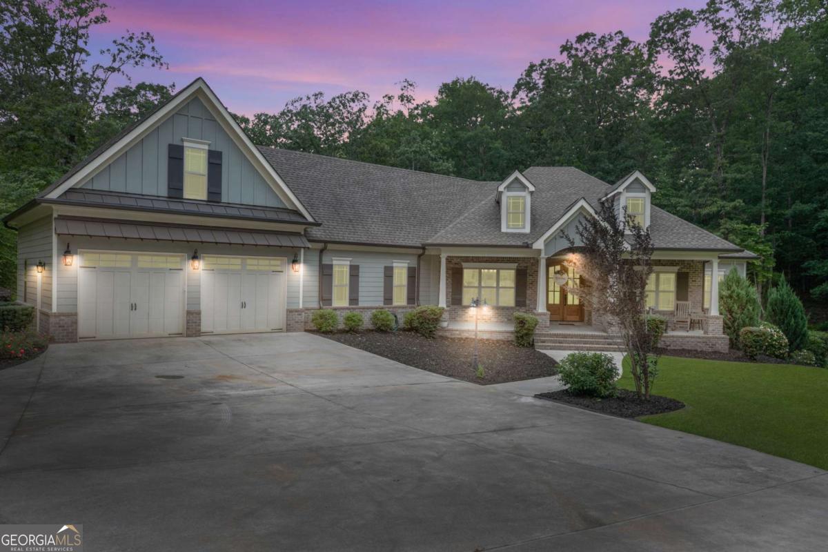 Welcome to this stunning custom built 5-bedroom, 3.5-bathroom home nestled in a serene, wooded setting on a beautifully landscaped lot. Enjoy peaceful mornings on the charming rocking chair front porch before stepping into an inviting open floor plan featuring beamed ceilings, a cozy fireplace, and built-in bookcases, and beautiful wide white oak plank floors. The gourmet kitchen is a chef's dream, complete with a large granite island, farmhouse sink, wine refrigerator, and a spacious walk-in pantry. It flows seamlessly into the elegant dining room and an office with French doors and a coffered ceiling. Step out onto the screened deck to take in the beauty of your private, wooded backyard. The lovely owner's suite offers a spa-like ensuite bath with a soaking tub, double vanities, and a separate shower. The oversized walk-in closet has a beautiful chandelier! The closet is conveniently connected to to a spacious laundry room. On the opposite wing, you'll find three additional bedrooms and a full bath. Above the garage is a massive finished bonus room perfect for guests, hobbies, or a playroom. The finished basement is an entertainer's paradise, offering a full kitchen with built-in kegorator, a large dining area with abundant cabinetry, family and game room space, a full bedroom and bath, plus a flex room ideal for a gym, office, or 6th bedroom. There's even a secure safe room! With multiple indoor and outdoor living spaces and endless versatility, this home truly has it all. Don't miss your chance to own this one-of-a-kind retreat!
