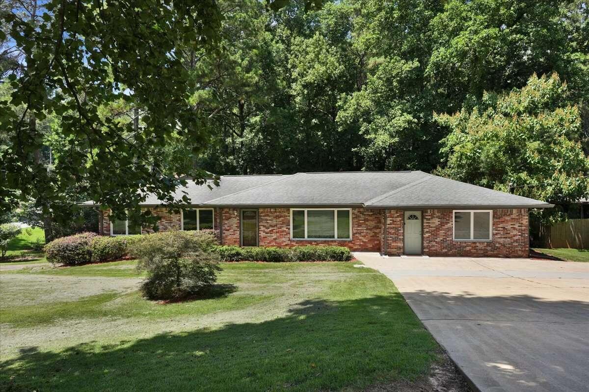 Discover endless possibilities in this captivating ranch-style home nestled on an inviting, over acre, corner lot. Positioned in a great location near shops, interstates, and downtown Tucker, this property offers the perfect blend of convenience and comfort. Less than a 10-minute walk away, Lucky Shoals Park provides an oasis for outdoor enthusiasts, while the Heritage Golf Links golf club is just a quick 2-minute drive, catering to leisure and recreation. With a full daylight basement and a serene flat backyard, this residence is an ideal canvas for creating the lifestyle you desire. Step inside to find two expansive living rooms radiating warmth, an adjacent dining room, and a sunlit breakfast area for casual meals. The main floor boasts three bedrooms and two baths, with the added charm of beautiful hardwood floors. The true gem lies in the ingenious full daylit basement, featuring a spacious storage area, an office space, cozy bedroom, and a full bathroom, all complemented by a living room and a fully equipped kitchen. With a private entrance and dedicated driveway, the basement is ideal for multi-family living or generating income. The new owners will have access to join local pool facilities, including Westhampton neighborhood pool, for a small annual fee. Embrace the potential of this remarkable property, where comfort meets versatility and the vibrant community offers an array of lifestyle options.