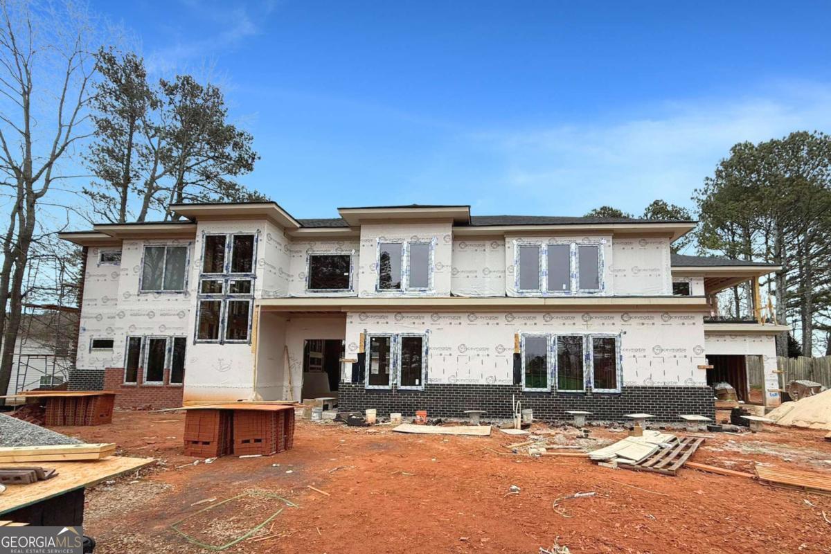 Experience contemporary luxury in this 4,660 sq ft modern masterpiece, currently under construction and located in the sought-after area of Lawrenceville, just off Collins Hill Rd. Crafted with a vision of elegance and functionality, this home promises to redefine upscale living in the heart of North Georgia. Designed by renowned developer Veera Venture, every element of this residence is meticulously planned to provide an extraordinary living experience. From its sleek, clean-lined exterior to thoughtfully planned spaces indoors, this home combines striking modern aesthetics with everyday practicality. Step into a grand, open-concept layout that flows effortlessly, filled with natural light from expansive windows that bring the outdoors in. The home is thoughtfully equipped for both family living and entertaining, featuring spacious living areas, a gourmet kitchen with high-end finishes, and ample room for guests. Enjoy seamless indoor-outdoor connectivity with covered patios that are perfect for lounging, dining, or entertaining year-round. As construction progresses, the home will also include a luxurious master suite designed to be a serene escape, complete with a spa-inspired bath and generous closet space. Additional bedrooms offer ample privacy and comfort, making this home ideal for growing families or hosting visitors. This is your chance to secure a home where modern design meets everyday convenience. Do not miss the opportunity to make this one-of-a-kind property yours!