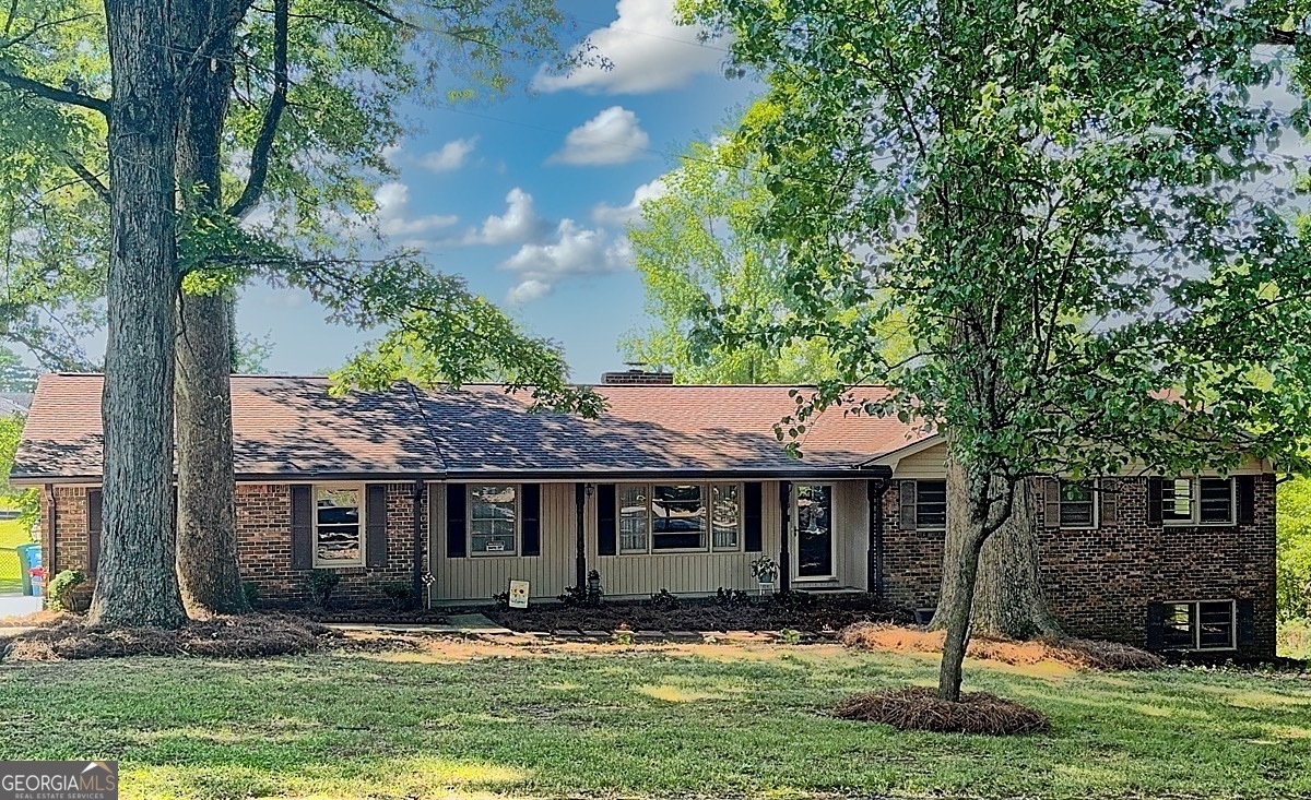 PRICED BELOW APPRAISED VALUE! Vintage Charm with Endless Possibilities in the Heart of Snellville. Welcome to your beautifully maintained all-brick ranch on a basement nestled on a spacious property in Snellville offering the perfect blend of comfort, charm, and opportunity! This classic 1969 home showcases over 1,900 square feet of living space, featuring 3 spacious bedrooms, 2 full bathrooms, a beautiful full length window sunroom and a partial basement with its own inside/outside entrance, ideal for a workshop, hobby space, or additional storage. Step inside to find freshly resurfaced original hardwood floors that add warmth and timeless character to every room. With a roof just 3 years old, plenty of storage, and a peaceful, friendly neighborhood setting, this home checks all the boxes and is MOVE-IN READY! Located in the heart of Snellville, you'll enjoy the perfect mix of city convenience and quiet suburban living. Just minutes from The Shoppes at Webb Gin, Lenora Park, Snellville Farmers Market, and Eastside Medical Center, plus easy access to dining of all types, entertainment, and top-rated schools. But wait, THERE'S MORE! This property includes an EXTRA BUILDING LOT, giving you INCREDIBLE OPTIONS! You could... (a) Build a second home (b) Expand your backyard for a pool, garden, play area OR (c) Sell the lot for extra cash! Whether you're dreaming of expanding, investing, or simply enjoying a solid, stylish home with space to grow, this is a RARE FIND you don't want to miss! Come see the potential. Fall in love with the charm. Make it yours.